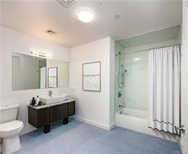 Full bathroom with vanity, toilet, and shower / bathtub combination with curtain Full bathroom with vanity, toilet, and shower / bathtub combination with curtain