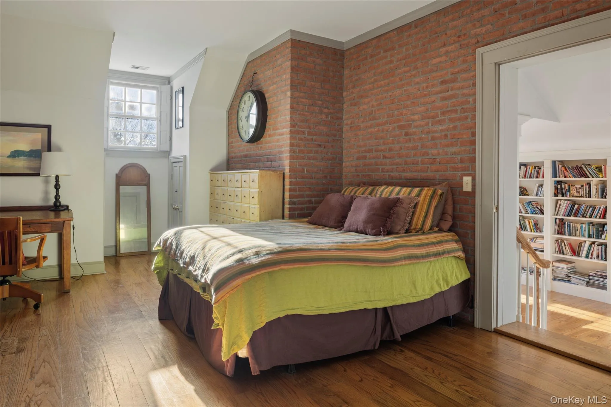 Bedroom with baseboards, visible vents, ornamental molding, and wood-type flooring Bedroom with baseboards, visible vents, ornamental molding, and wood-type flooring