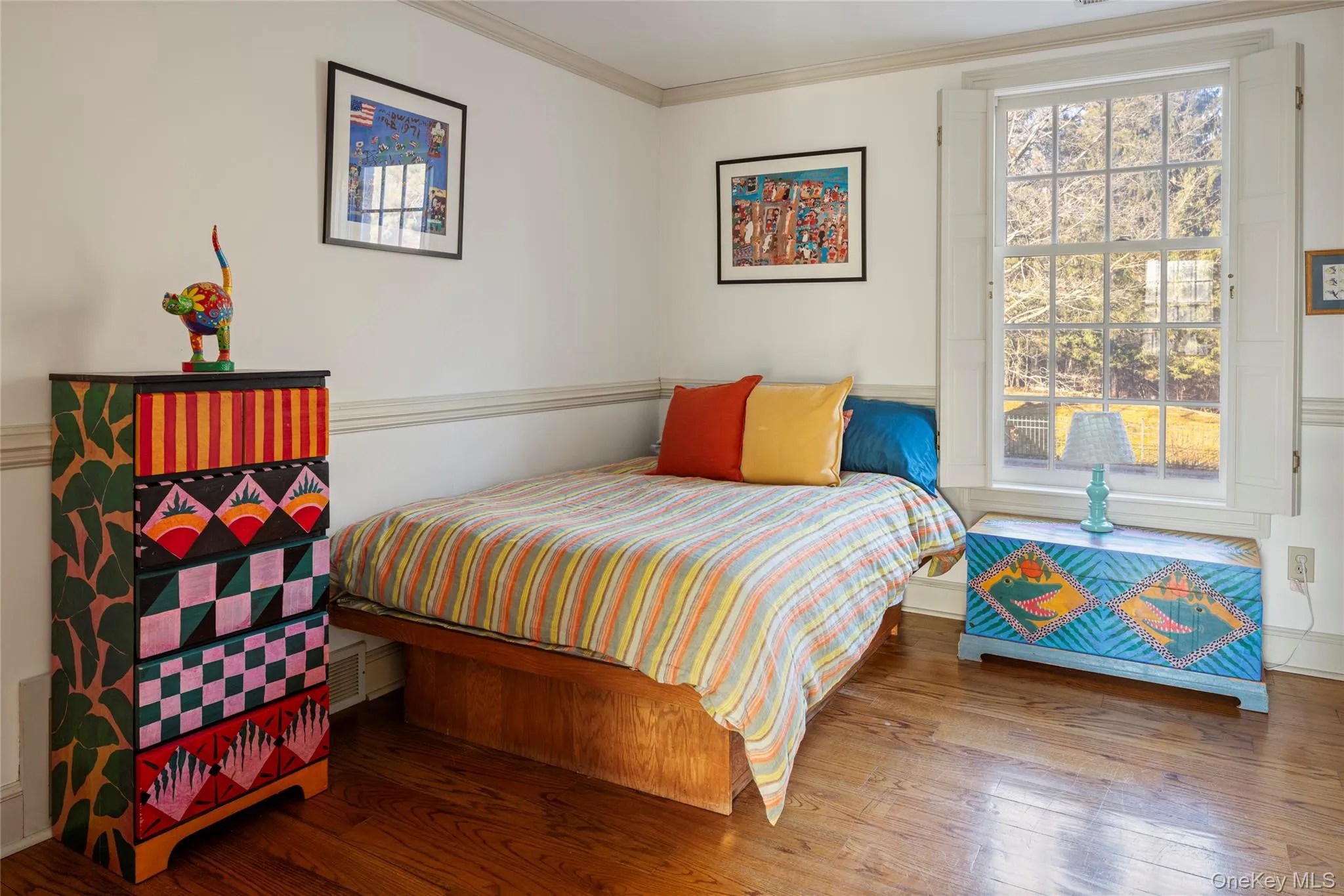 Bedroom with wood finished floors and crown molding Bedroom with wood finished floors and crown molding