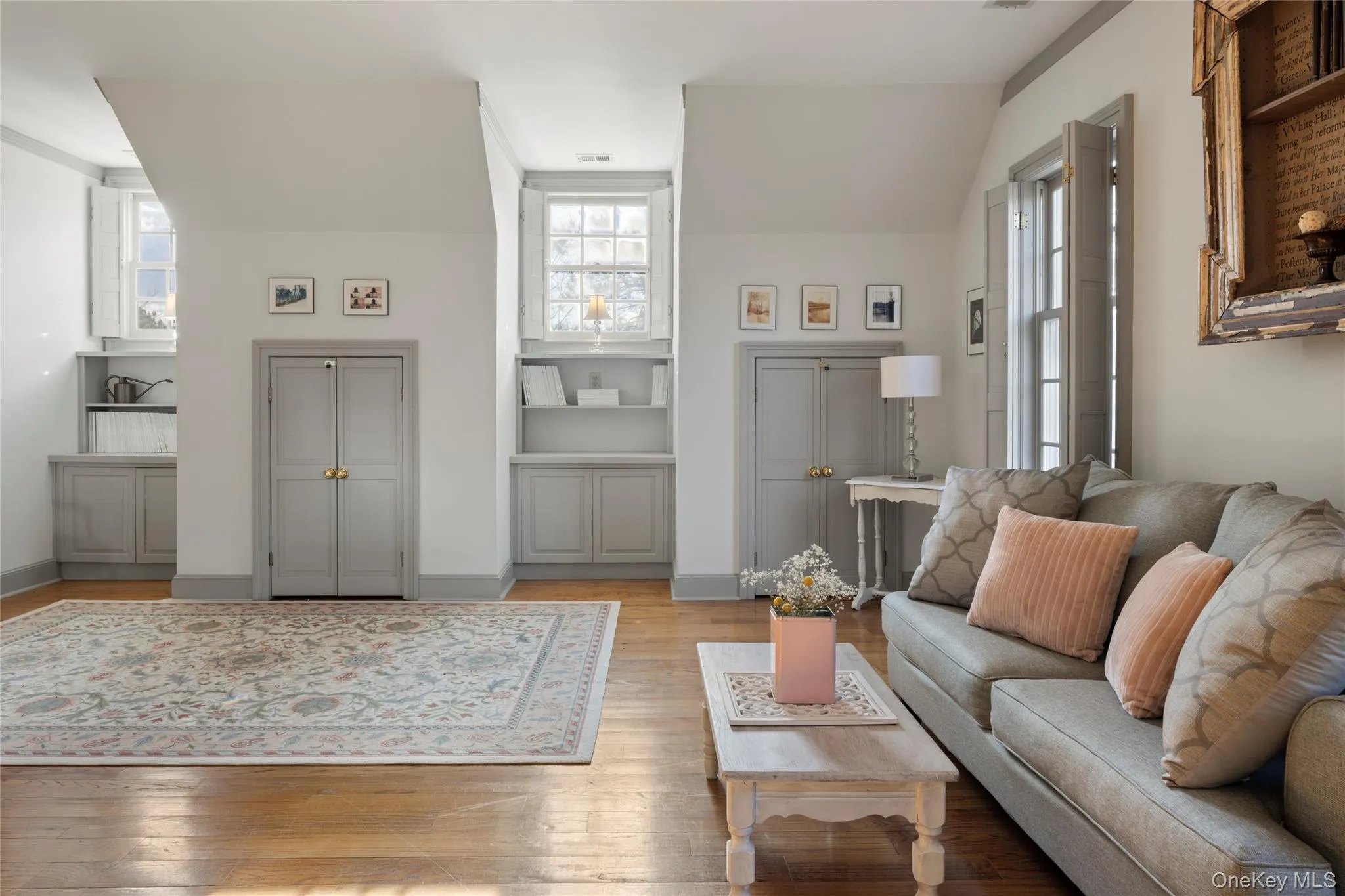 Living area featuring light wood-type flooring, visible vents, and baseboards Living area featuring light wood-type flooring, visible vents, and baseboards