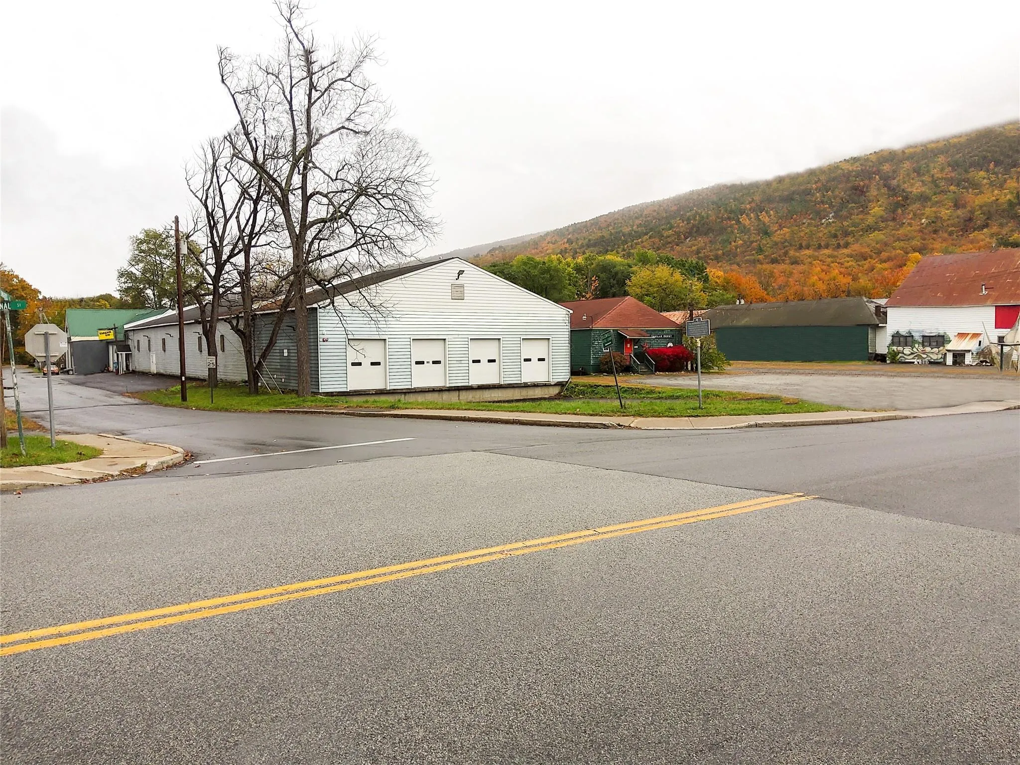 View of street featuring curbs, sidewalks, and a mountain view View of street featuring curbs, sidewalks, and a mountain view