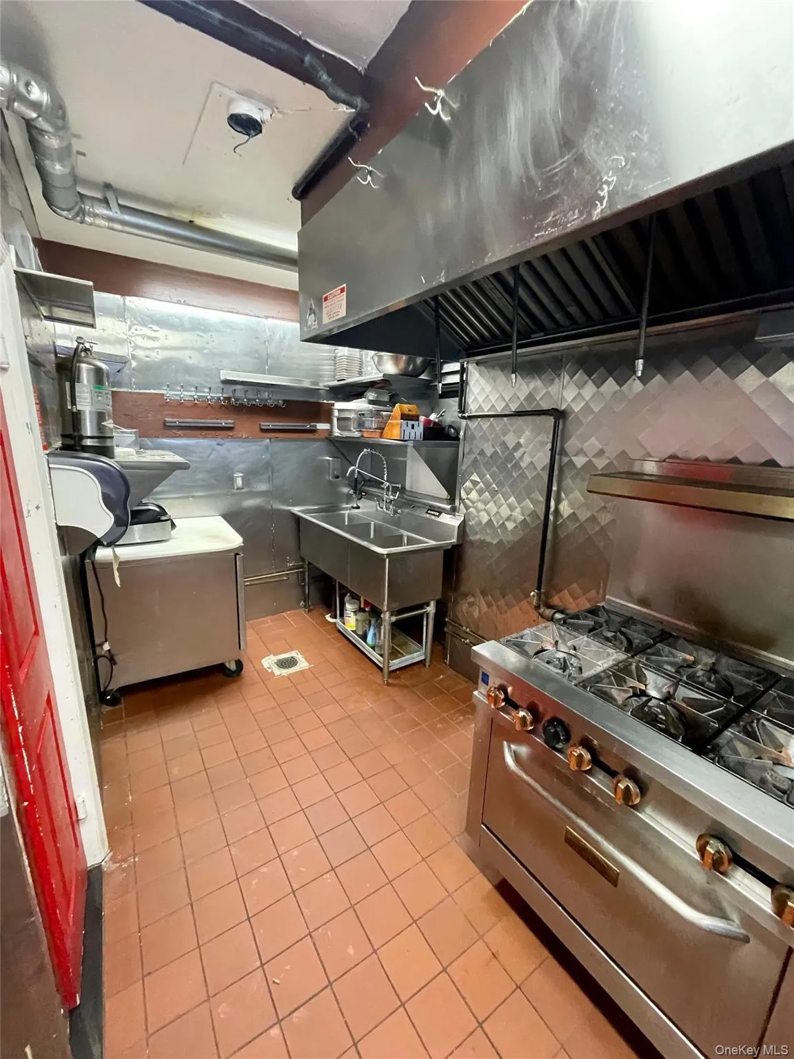 Kitchen featuring high end stainless steel range and range hood Kitchen featuring high end stainless steel range and range hood