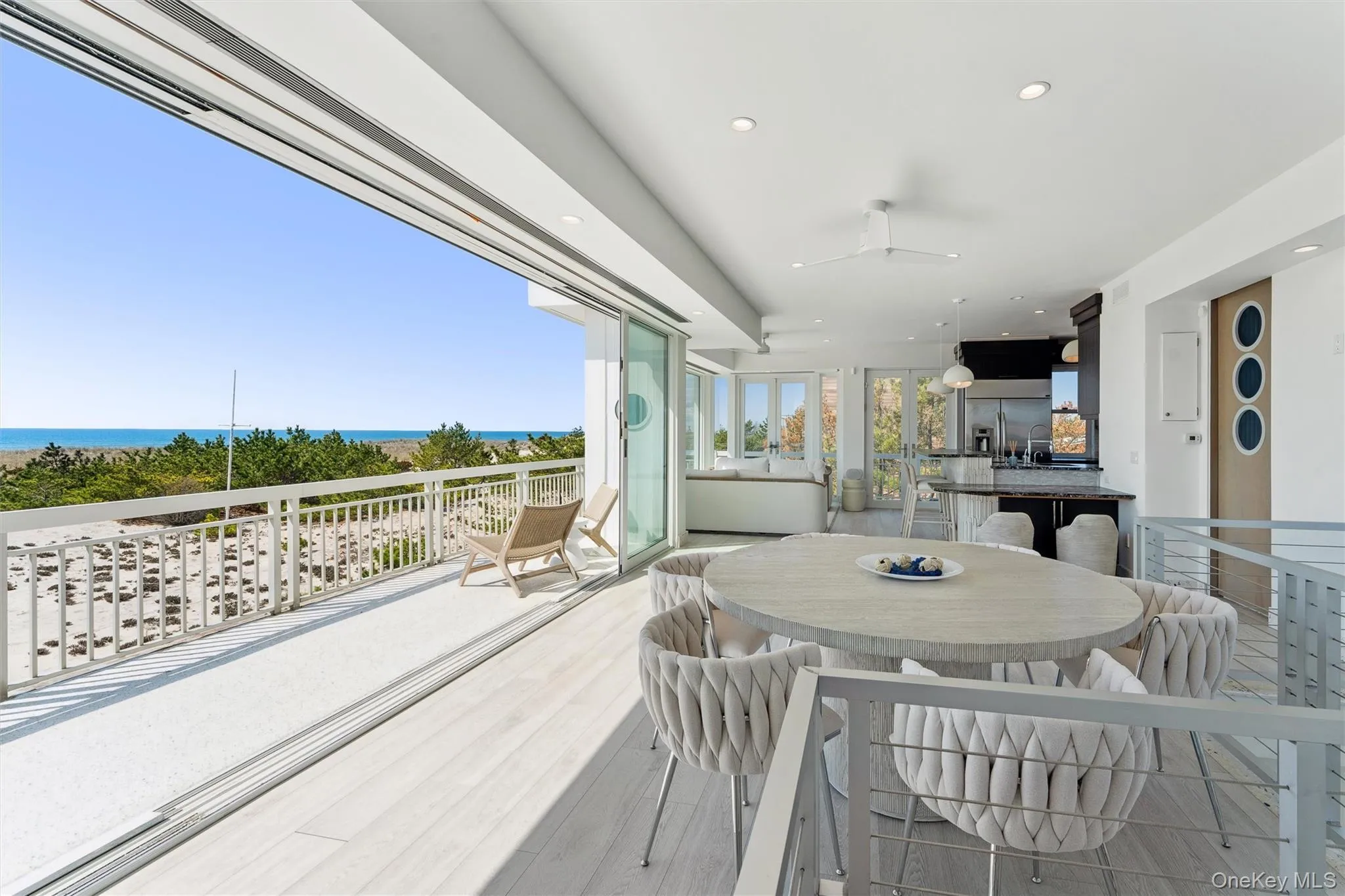 Wooden terrace featuring a ceiling fan, a water view, and outdoor dining area Wooden terrace featuring a ceiling fan, a water view, and outdoor dining area