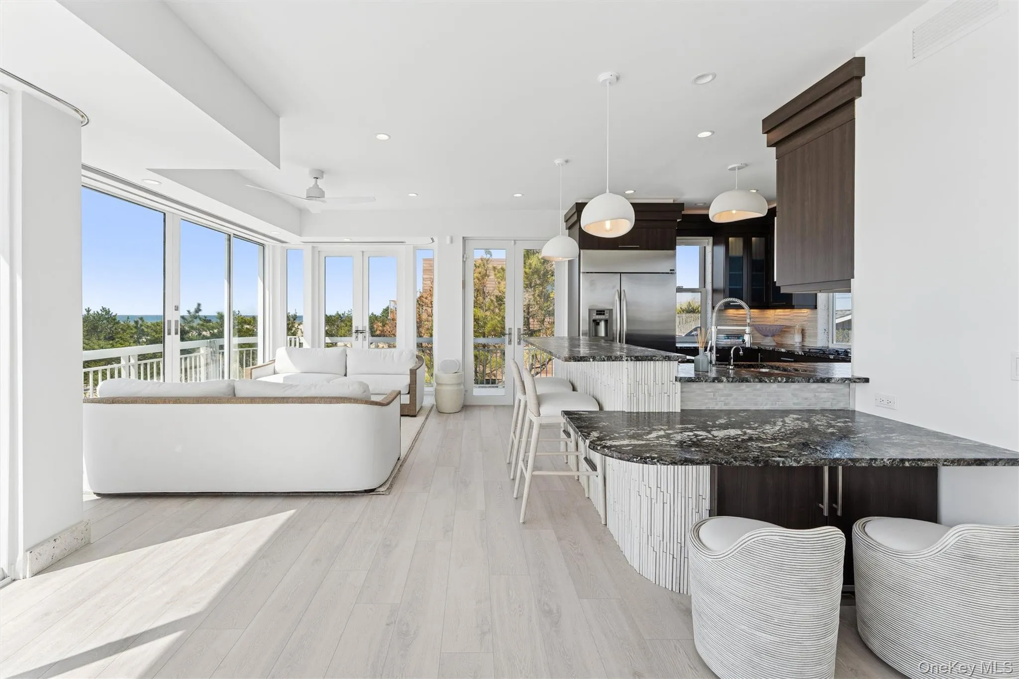 Living room featuring recessed lighting, a ceiling fan, visible vents, and light wood-type flooring Living room featuring recessed lighting, a ceiling fan, visible vents, and light wood-type flooring