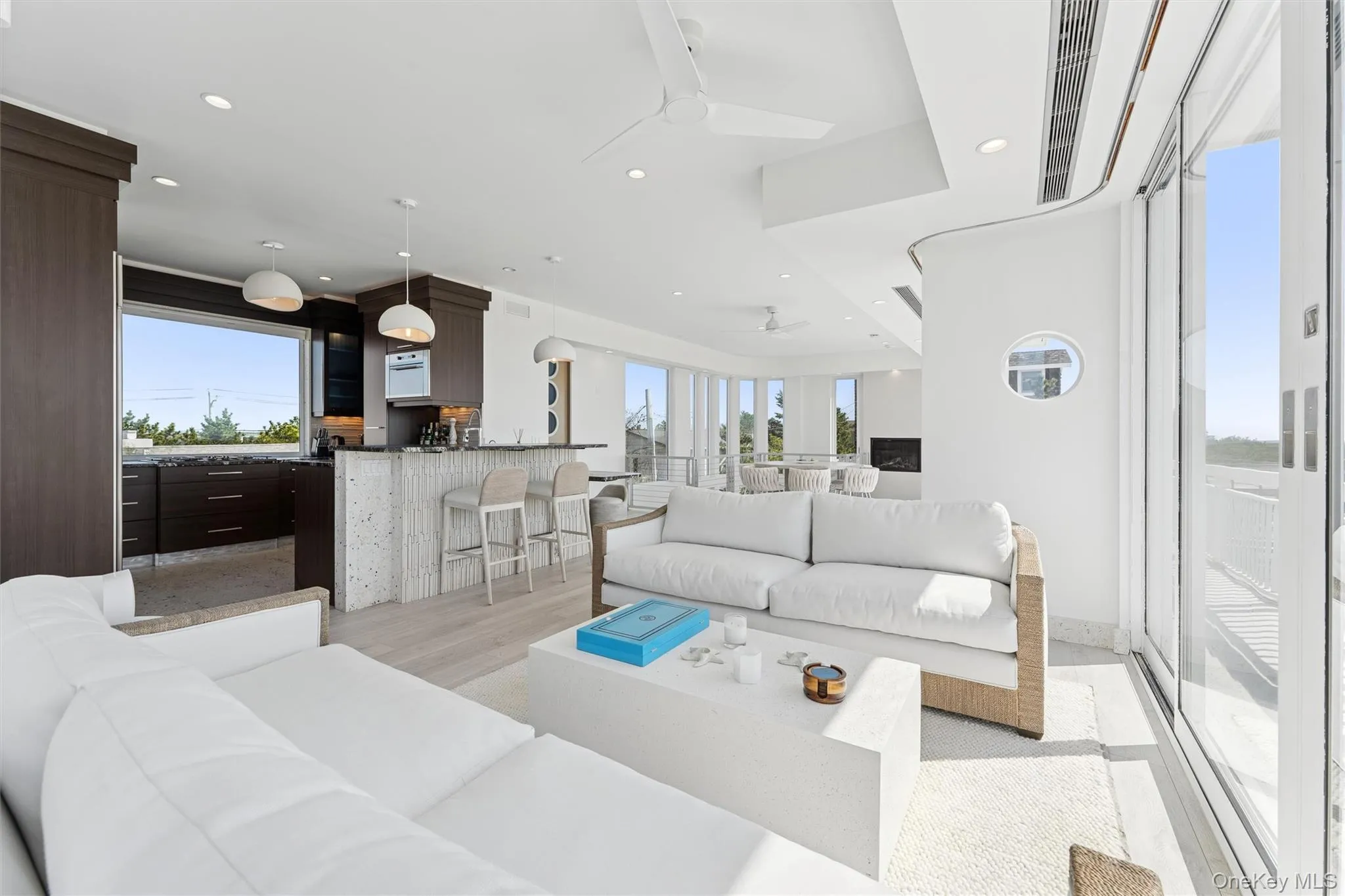 Living area featuring recessed lighting, visible vents, ceiling fan, and plenty of natural light Living area featuring recessed lighting, visible vents, ceiling fan, and plenty of natural light