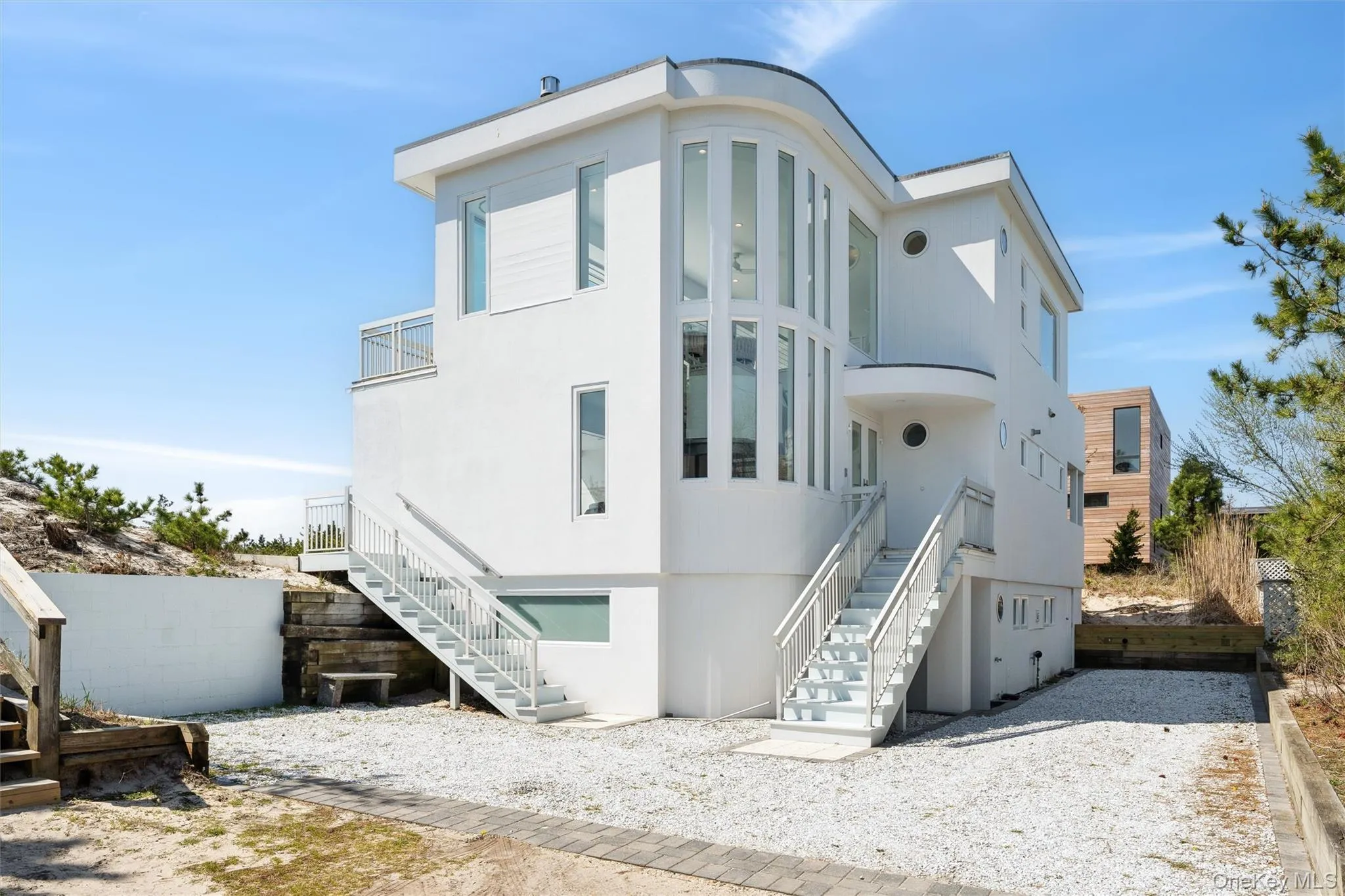Back of property with stucco siding and stairs Back of property with stucco siding and stairs