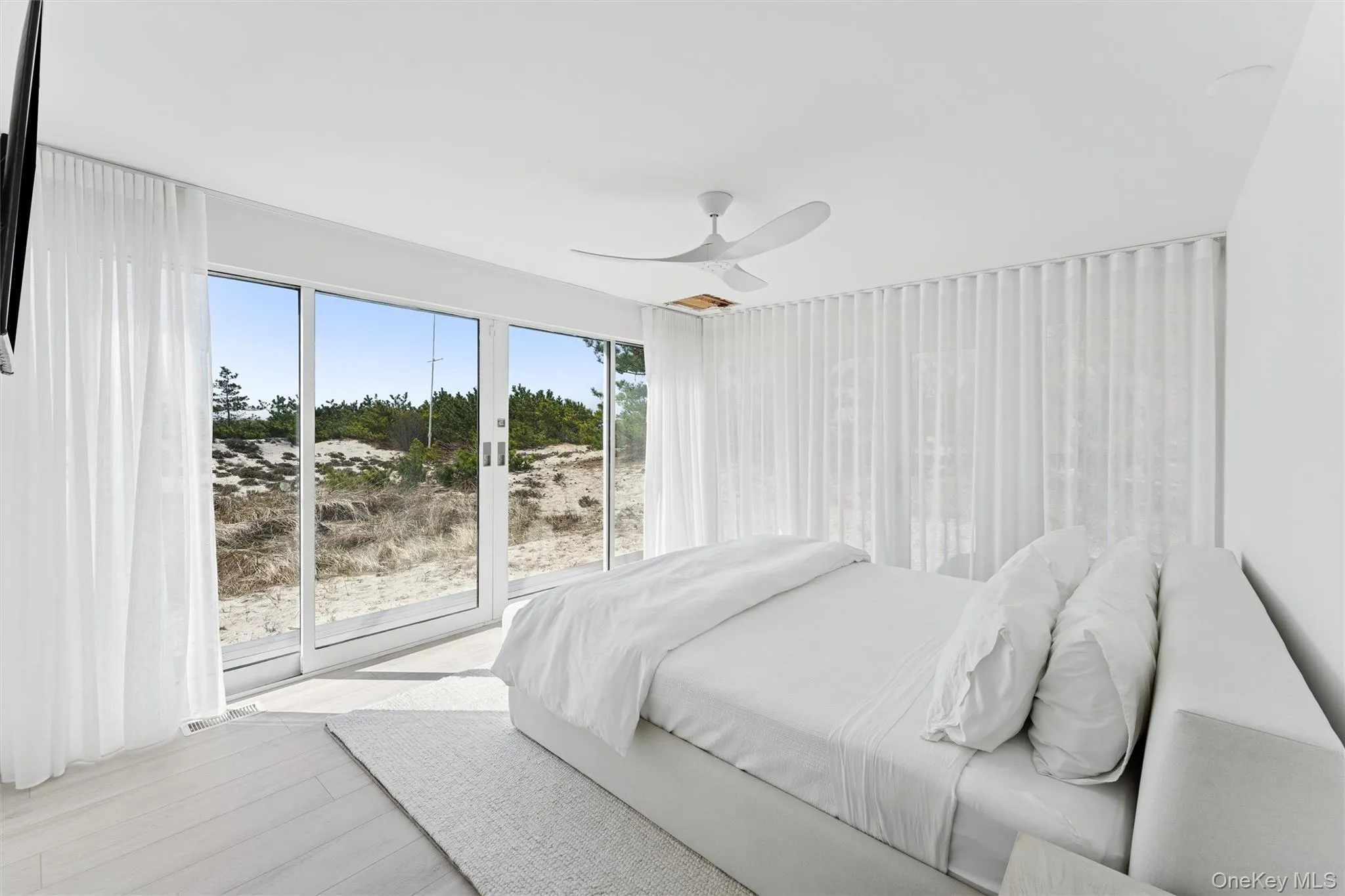 Bedroom featuring access to outside, light wood finished floors, and ceiling fan Bedroom featuring access to outside, light wood finished floors, and ceiling fan