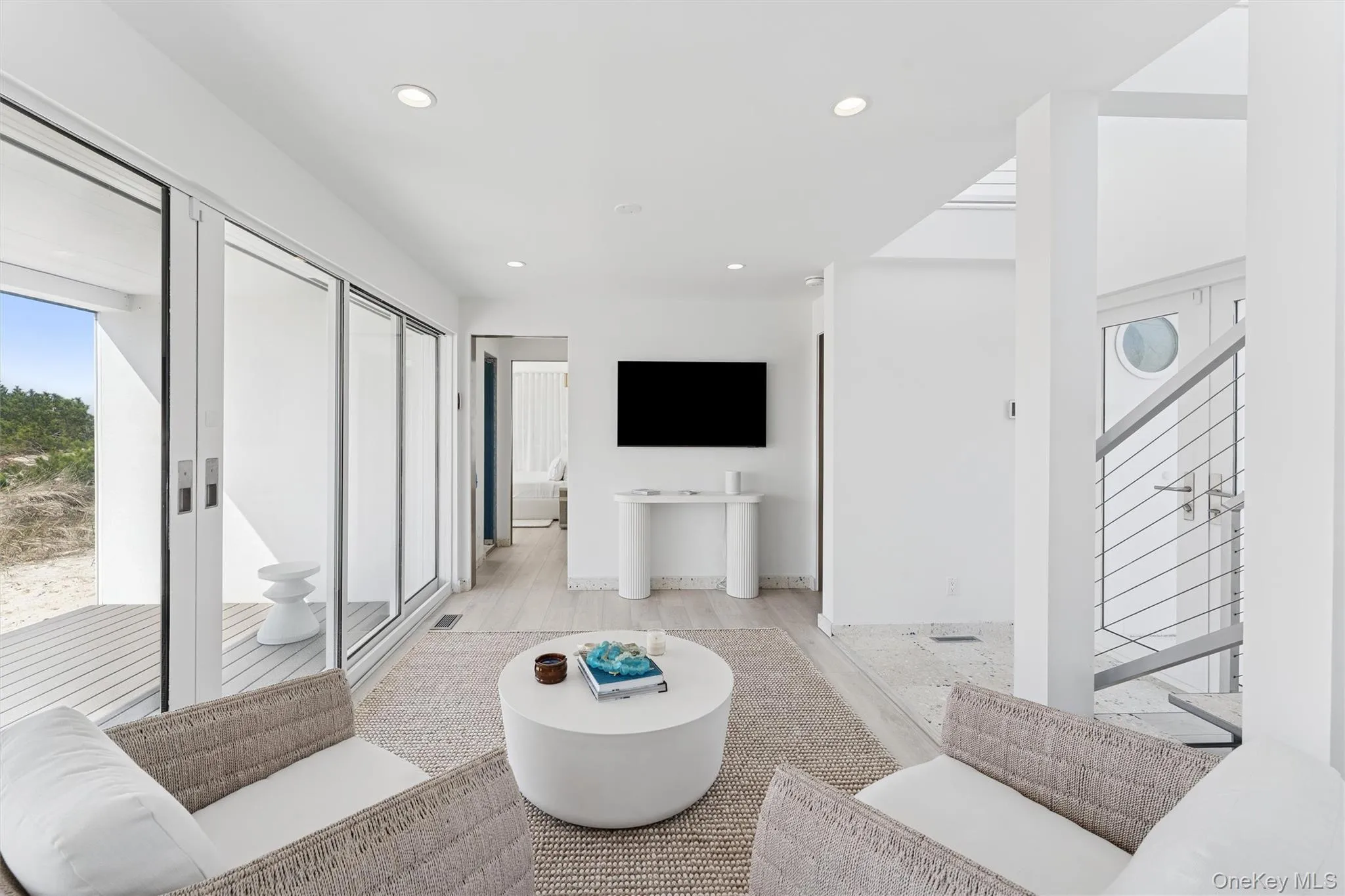 Living area featuring light wood-style floors, recessed lighting, and visible vents Living area featuring light wood-style floors, recessed lighting, and visible vents