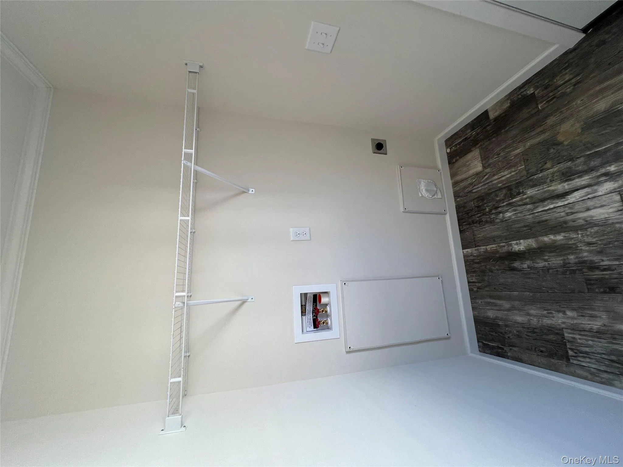 Clothes washing area featuring hookup for an electric dryer, washer hookup, baseboards, dark wood-style flooring, and laundry area Clothes washing area featuring hookup for an electric dryer, washer hookup, baseboards, dark wood-style flooring, and laundry area