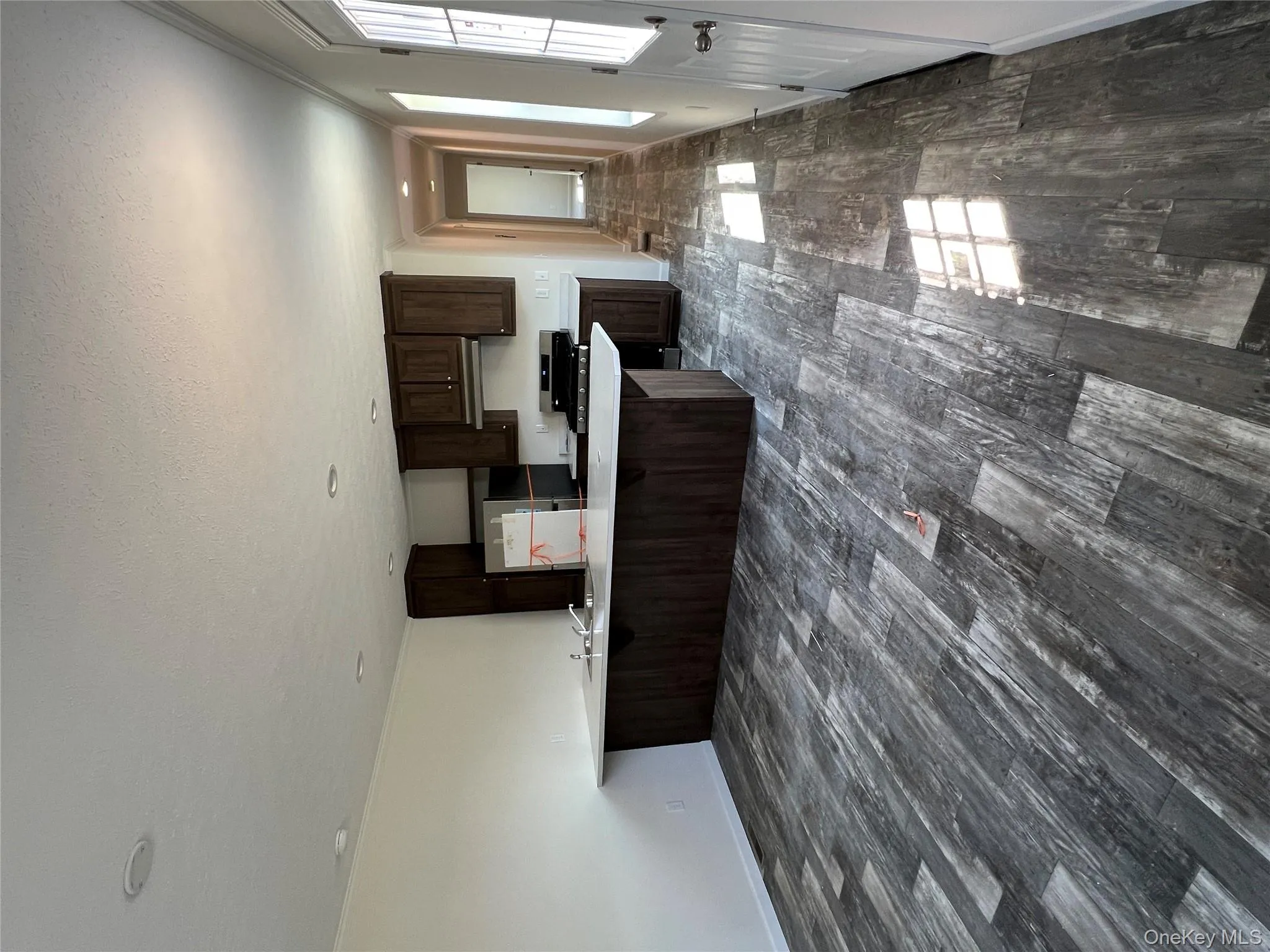 Kitchen featuring dark brown cabinetry, fridge, range, light countertops, and dark wood-type flooring Kitchen featuring dark brown cabinetry, fridge, range, light countertops, and dark wood-type flooring