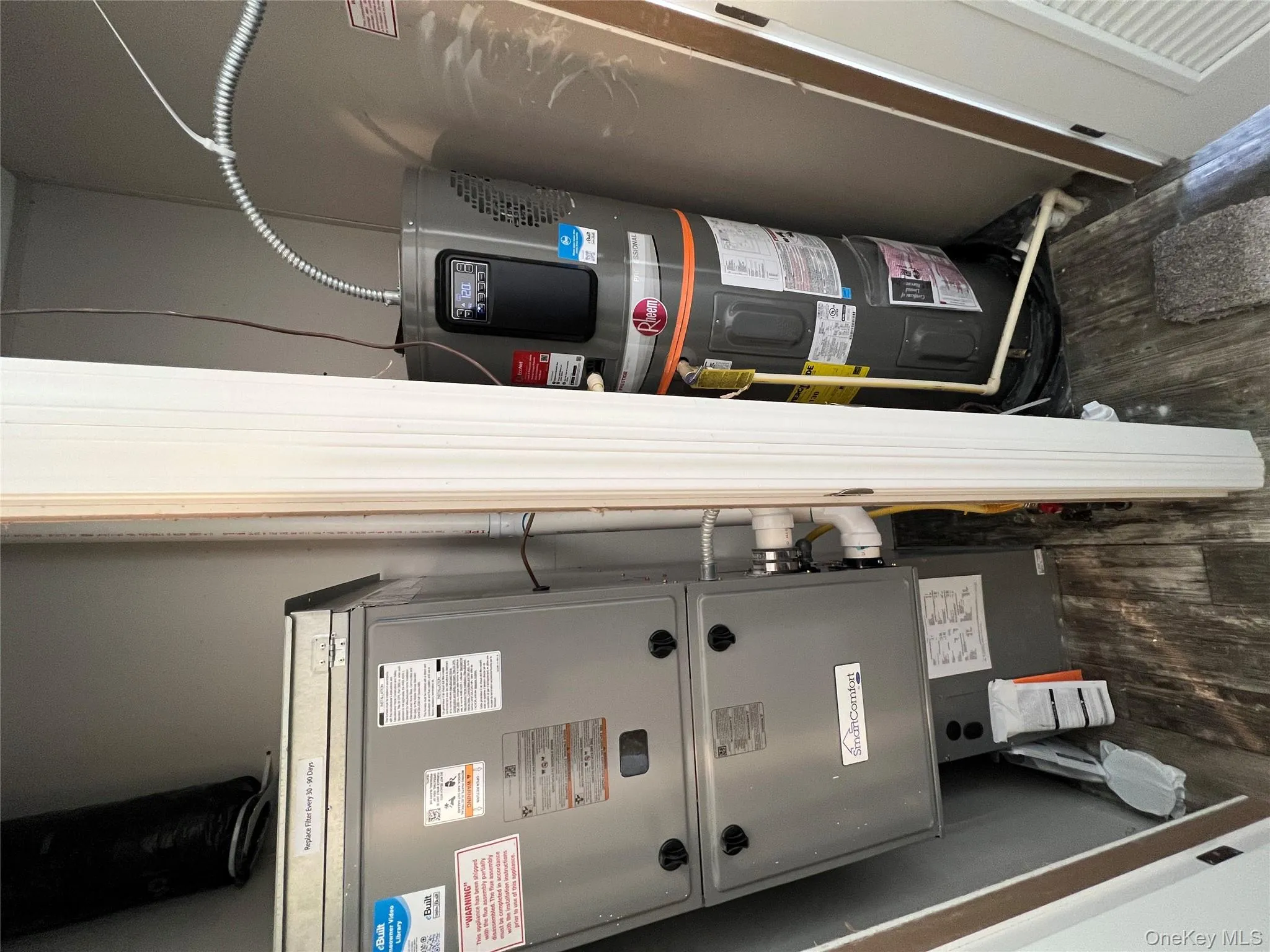 Utilities featuring heating unit and water heater Utilities featuring heating unit and water heater