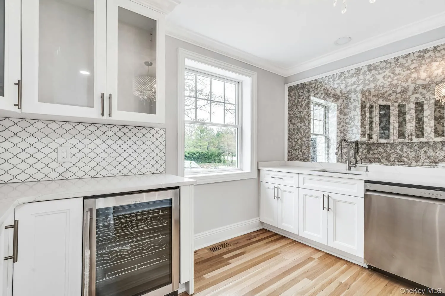 Bar with ornamental molding, wine cooler, dishwasher, a sink, and backsplash Bar with ornamental molding, wine cooler, dishwasher, a sink, and backsplash
