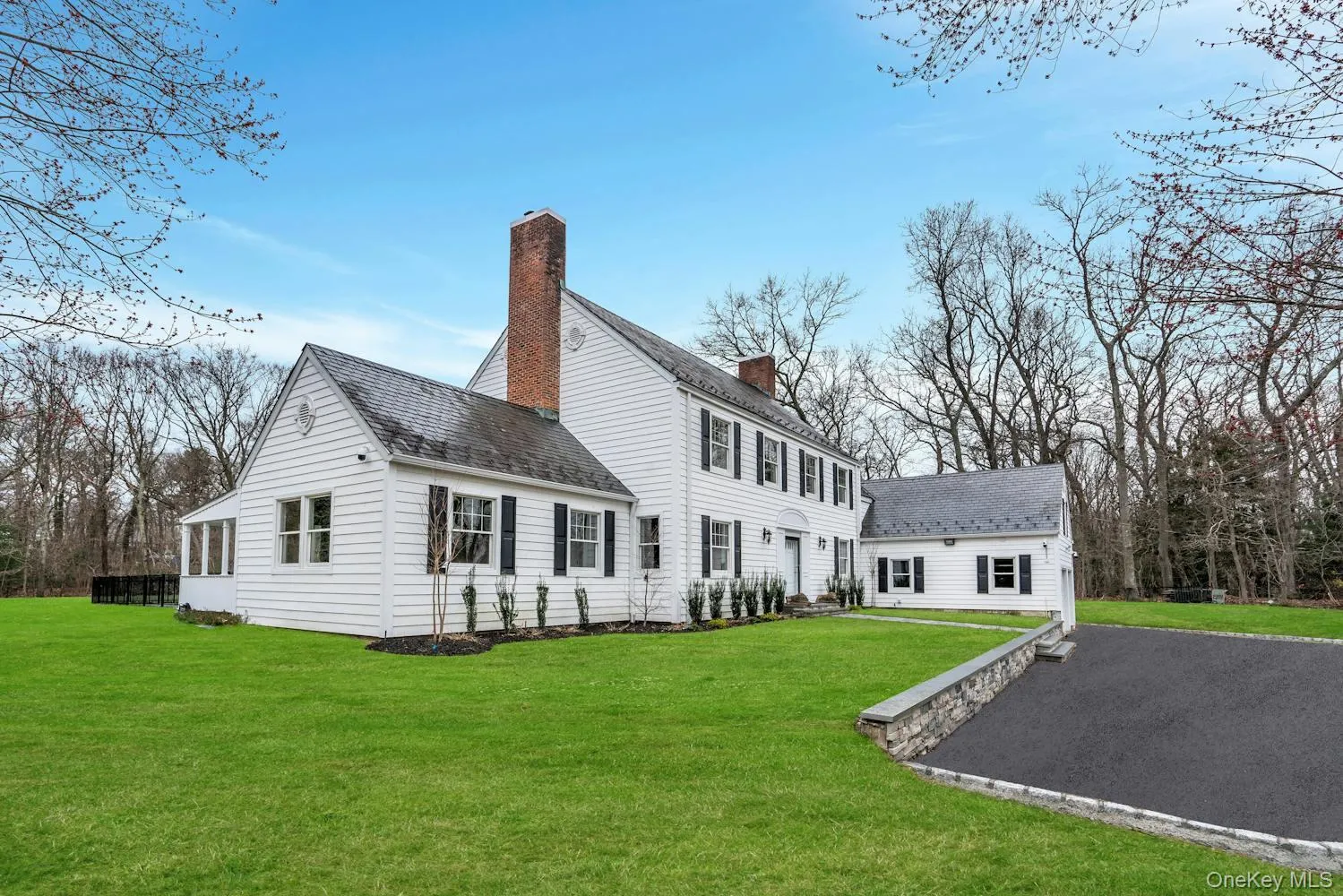 Back of house featuring a yard, a chimney, and a shingled roof Back of house featuring a yard, a chimney, and a shingled roof