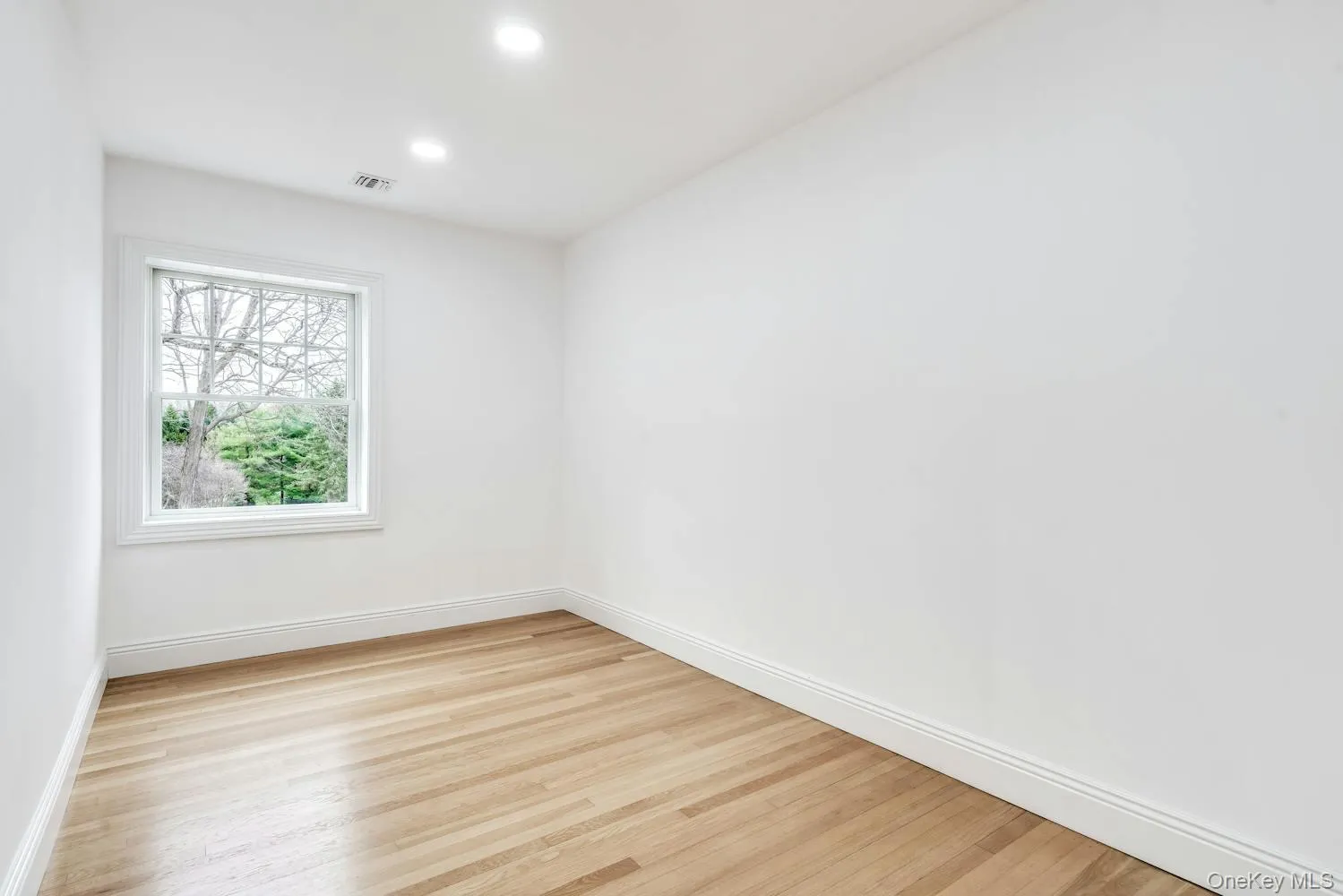 Spare room with visible vents, recessed lighting, light wood-style flooring, and baseboards Spare room with visible vents, recessed lighting, light wood-style flooring, and baseboards
