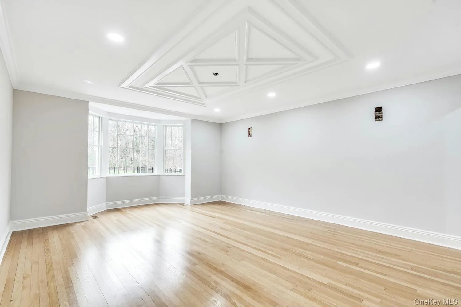 Empty room featuring light wood-style floors, recessed lighting, and baseboards Empty room featuring light wood-style floors, recessed lighting, and baseboards