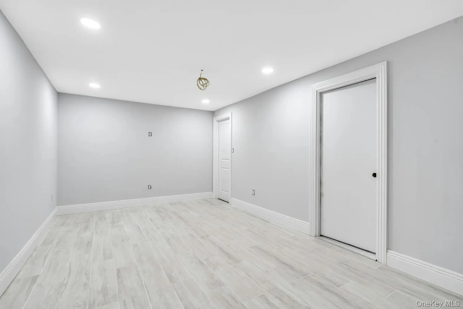 Below grade area featuring baseboards, light wood finished floors, and recessed lighting Below grade area featuring baseboards, light wood finished floors, and recessed lighting