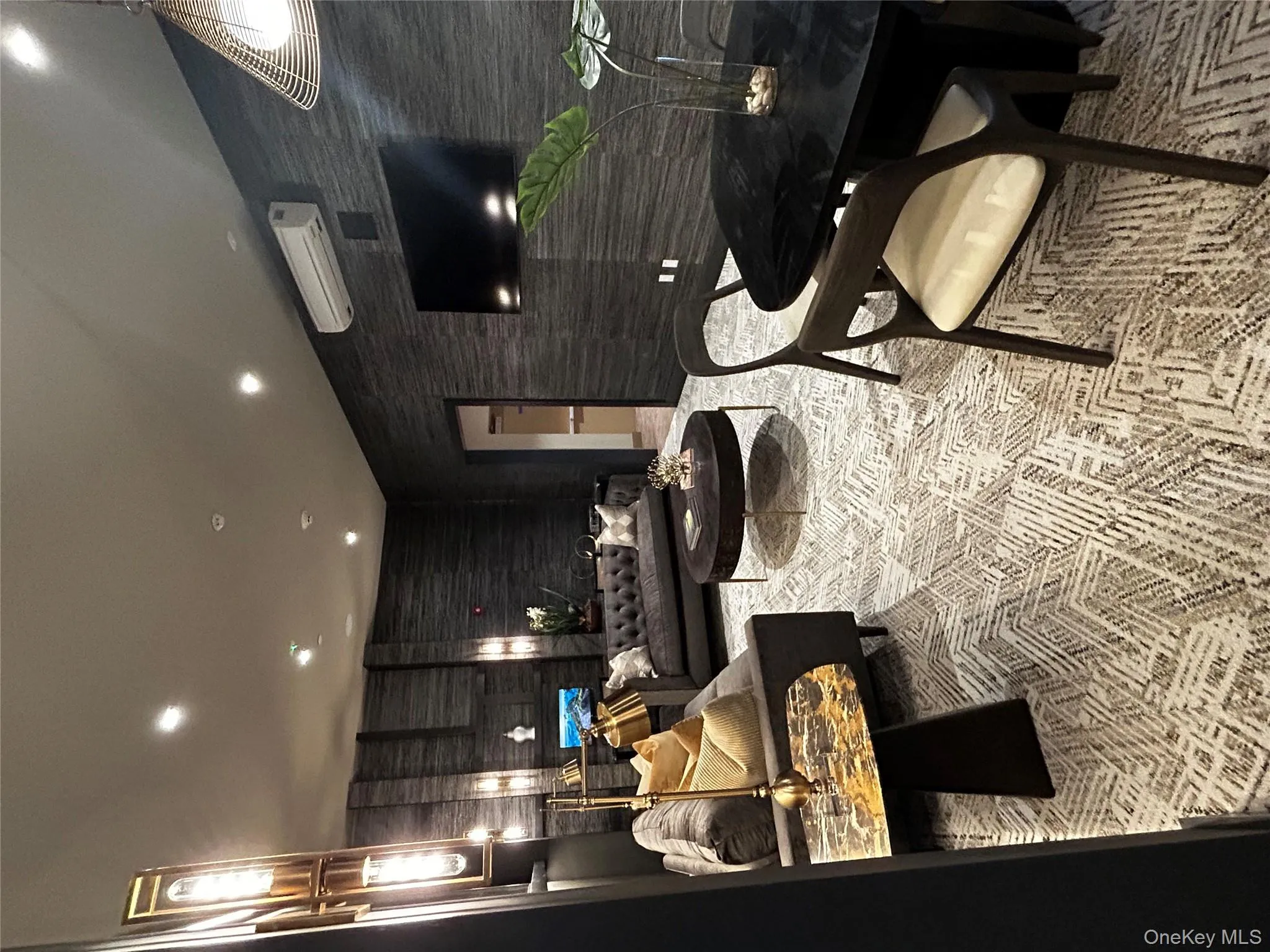 Living area featuring recessed lighting and a wall mounted air conditioner Living area featuring recessed lighting and a wall mounted air conditioner