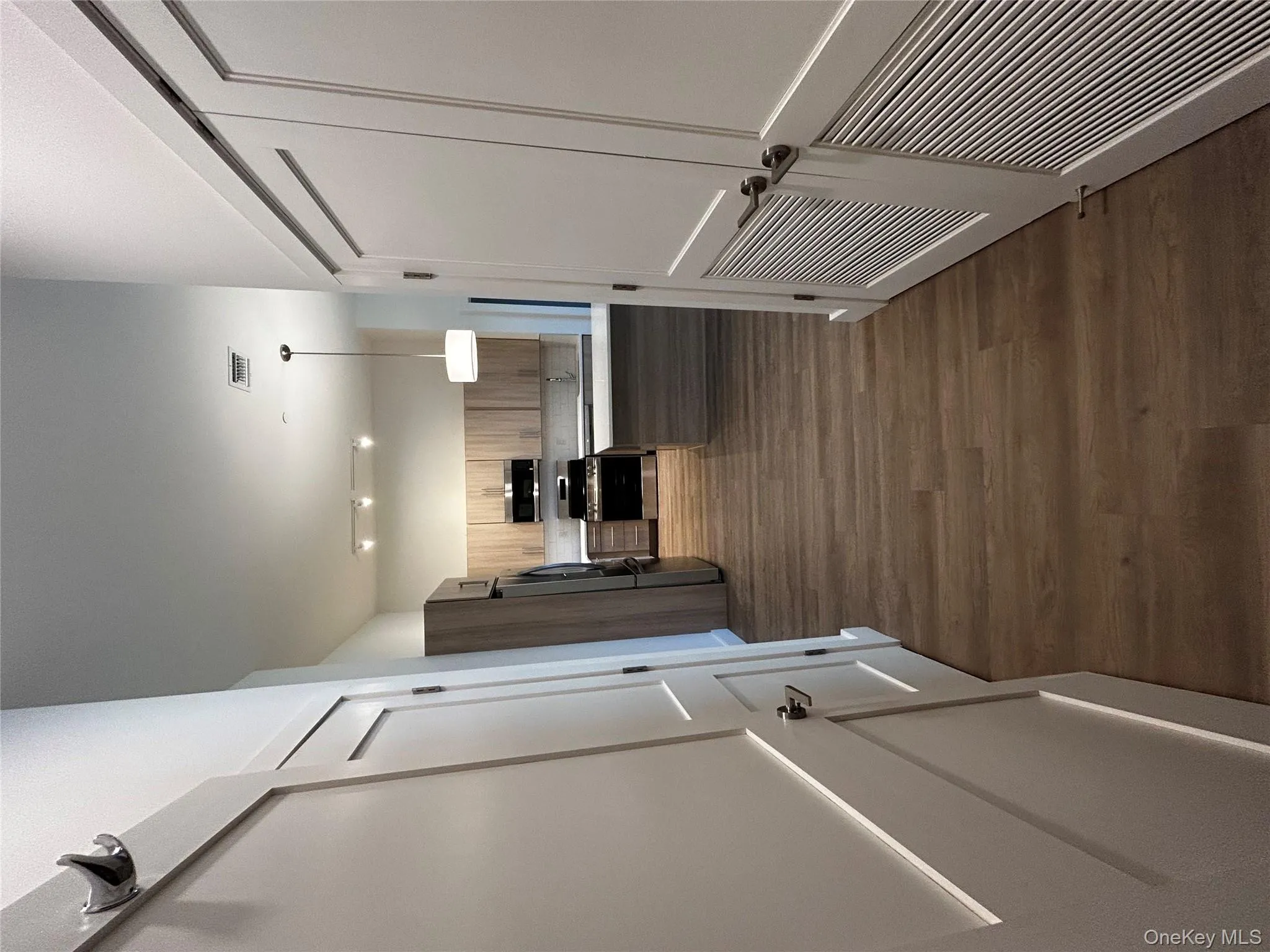 Hall featuring dark wood-style floors and visible vents Hall featuring dark wood-style floors and visible vents