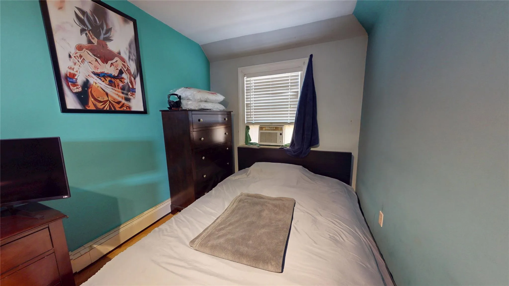 Bedroom with baseboards, cooling unit, and vaulted ceiling Bedroom with baseboards, cooling unit, and vaulted ceiling