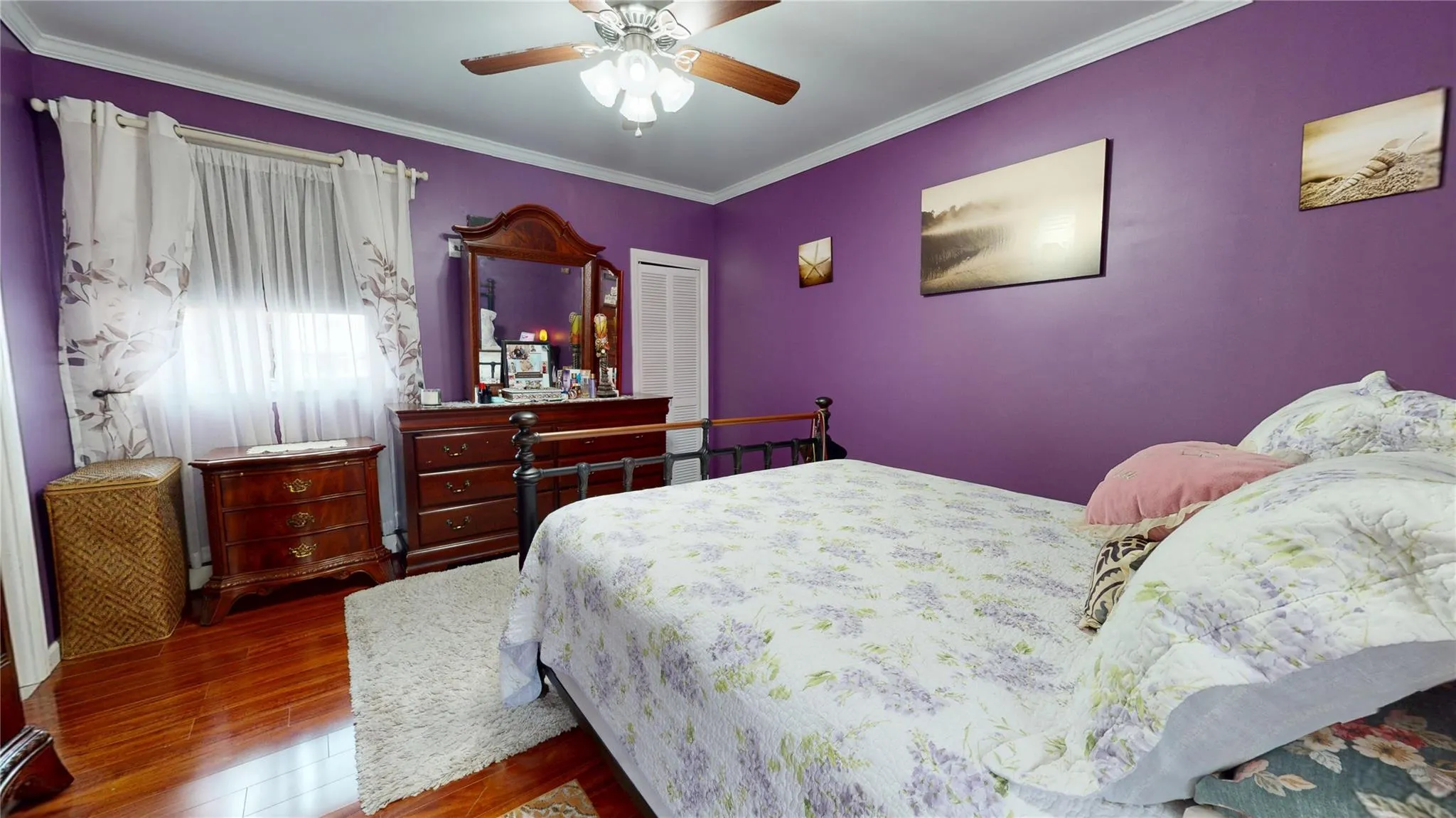 Bedroom featuring ornamental molding, a closet, ceiling fan, and wood finished floors Bedroom featuring ornamental molding, a closet, ceiling fan, and wood finished floors