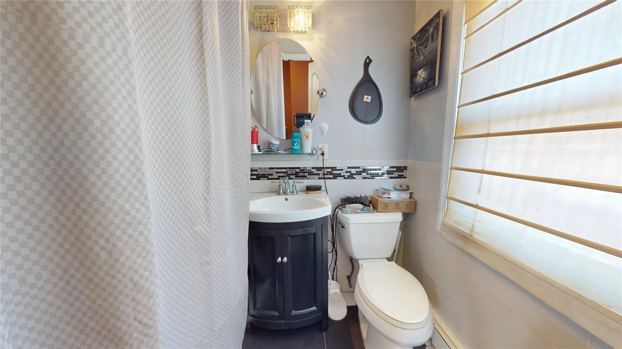 Full bathroom featuring tile walls, toilet, and vanity Full bathroom featuring tile walls, toilet, and vanity