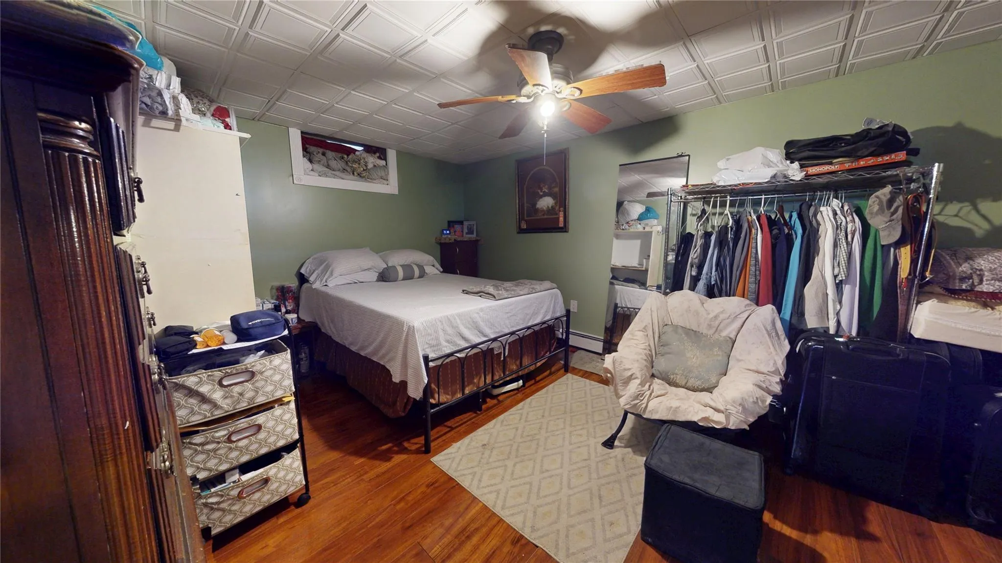 Bedroom with wood finished floors, ceiling fan, and a closet Bedroom with wood finished floors, ceiling fan, and a closet