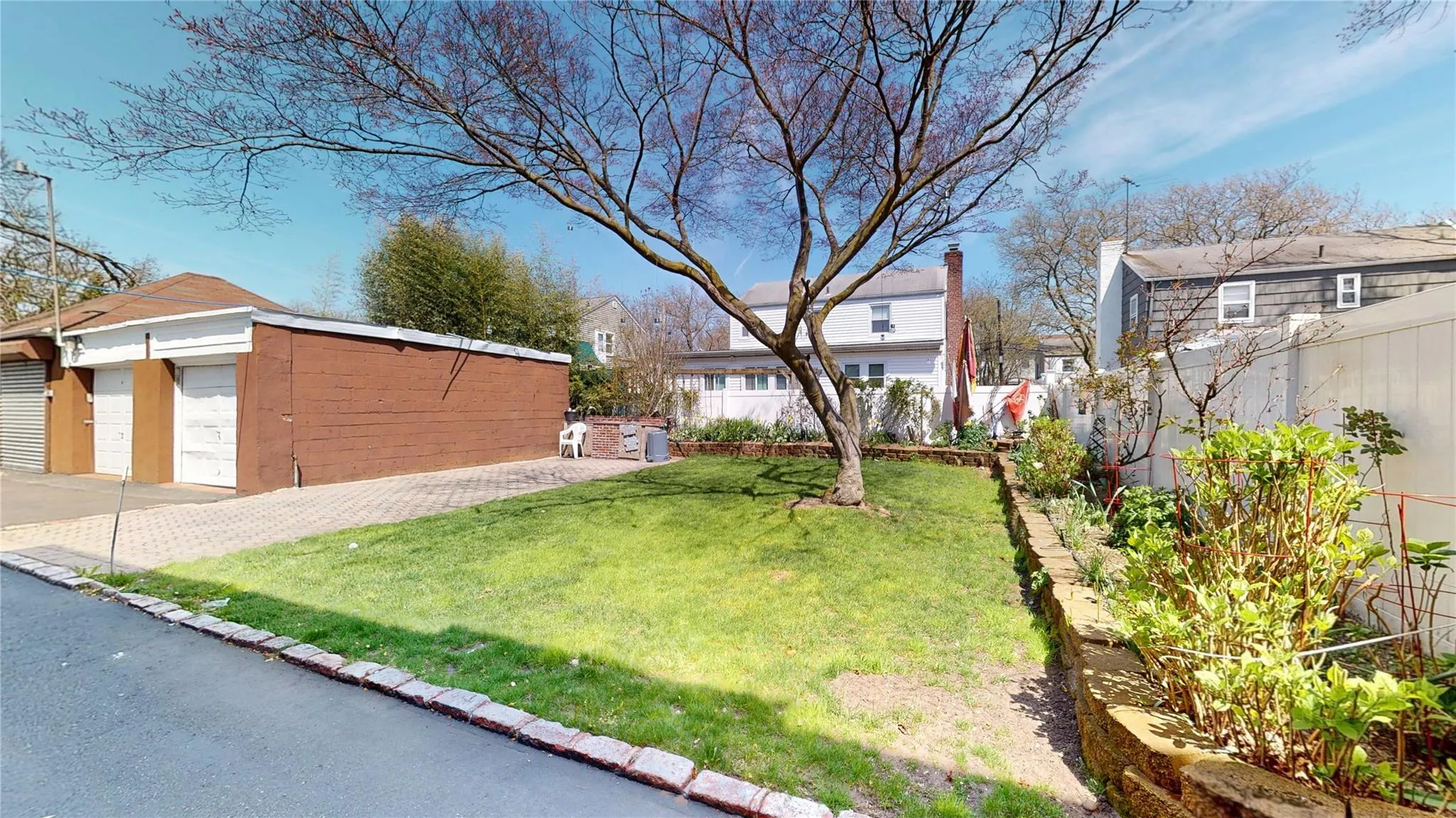 View of yard with an outbuilding, a detached garage, and fence View of yard with an outbuilding, a detached garage, and fence