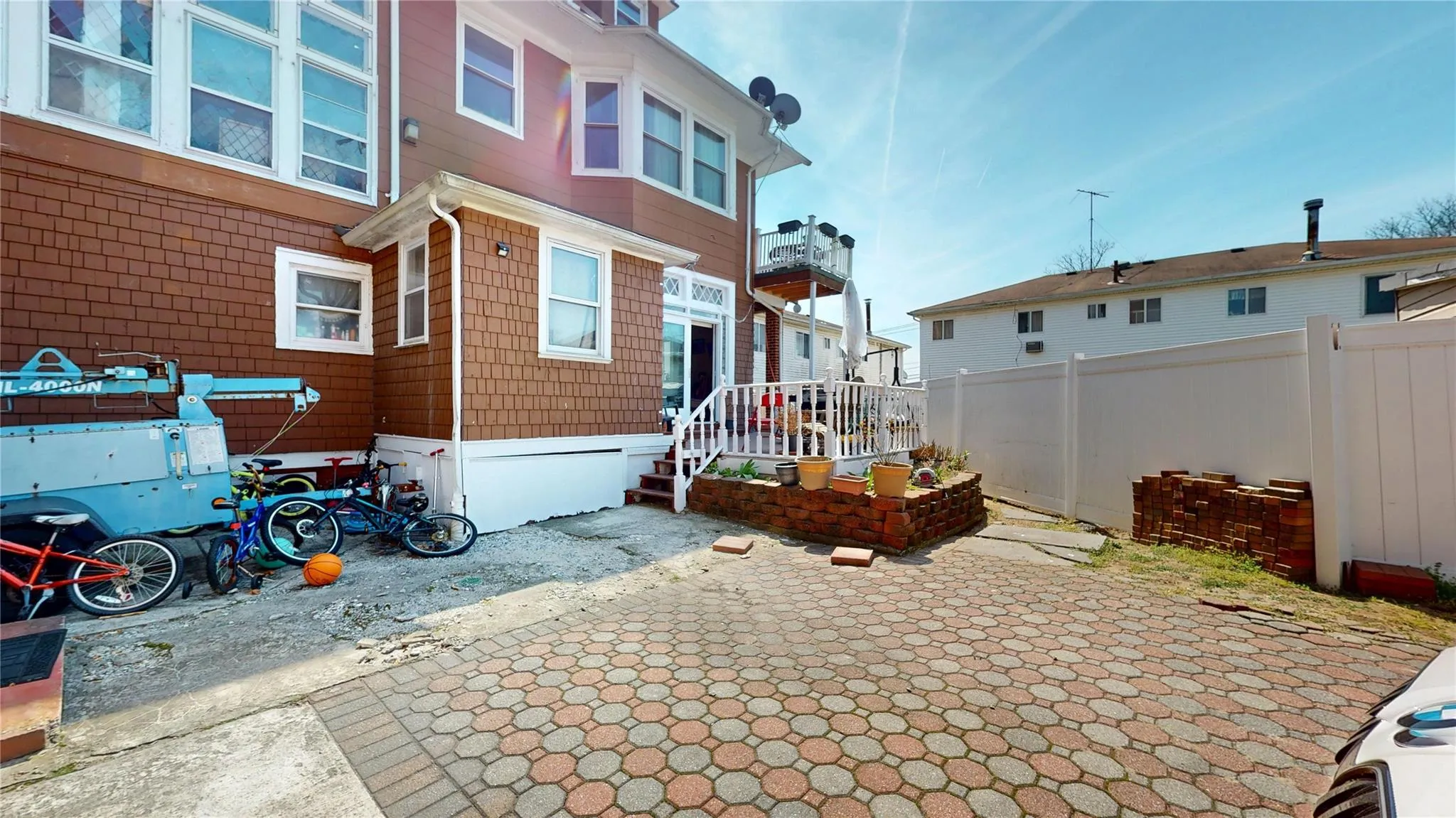 Rear view of house with fence and a patio Rear view of house with fence and a patio