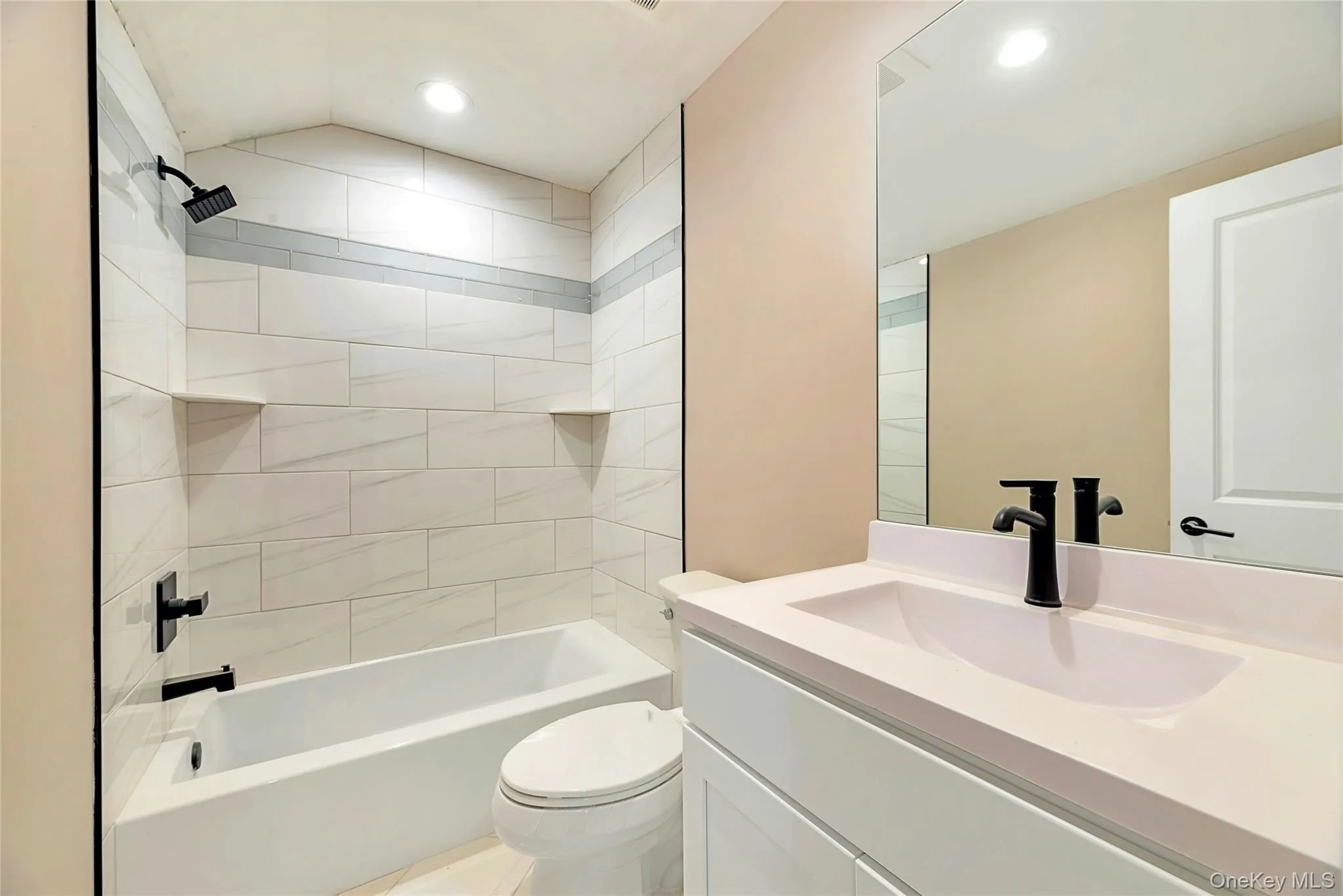 Full bath with washtub / shower combination, vanity, and recessed lighting Full bath with washtub / shower combination, vanity, and recessed lighting