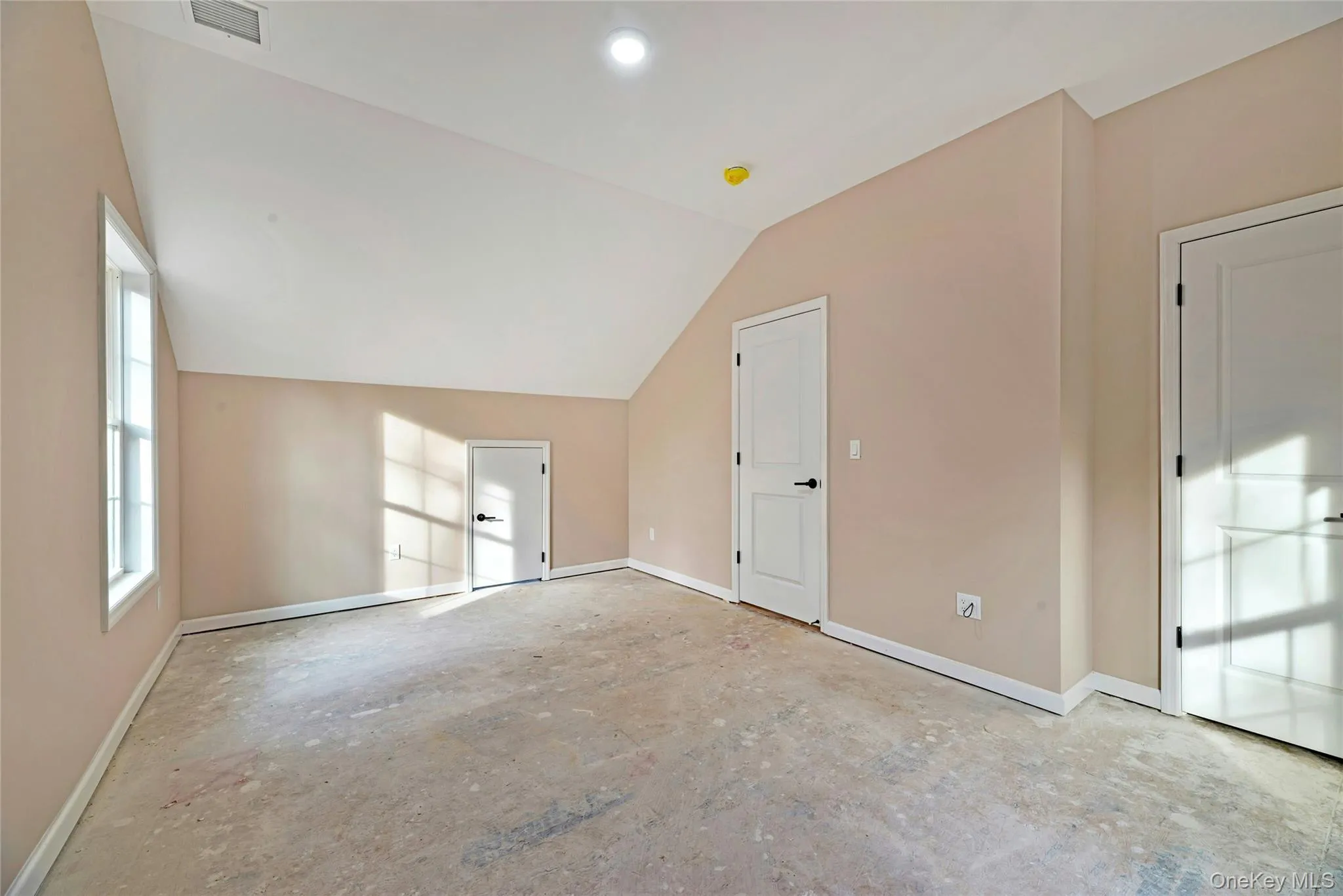 Additional living space featuring baseboards and vaulted ceiling Additional living space featuring baseboards and vaulted ceiling