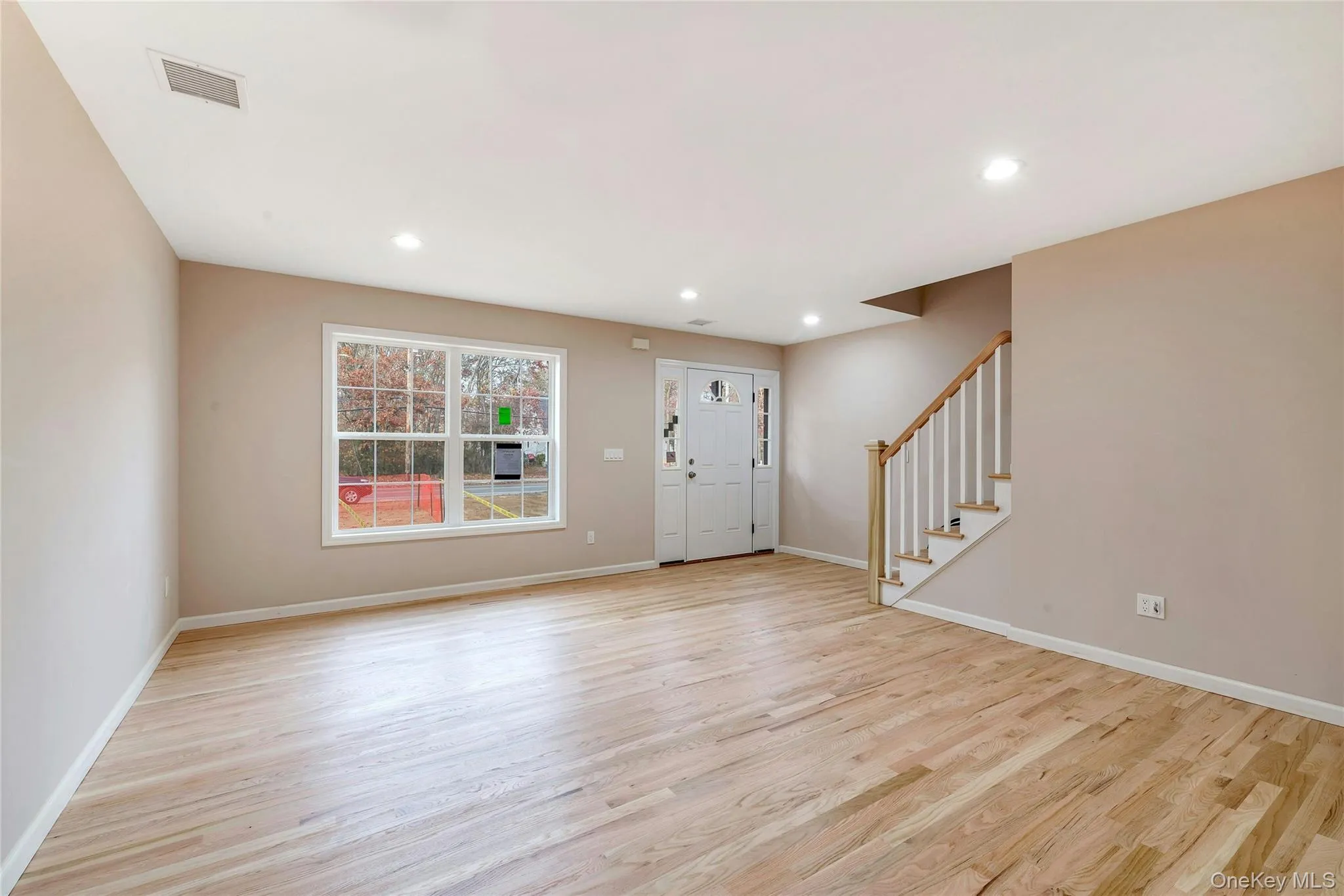 Entryway with stairs, light wood finished floors, and recessed lighting Entryway with stairs, light wood finished floors, and recessed lighting