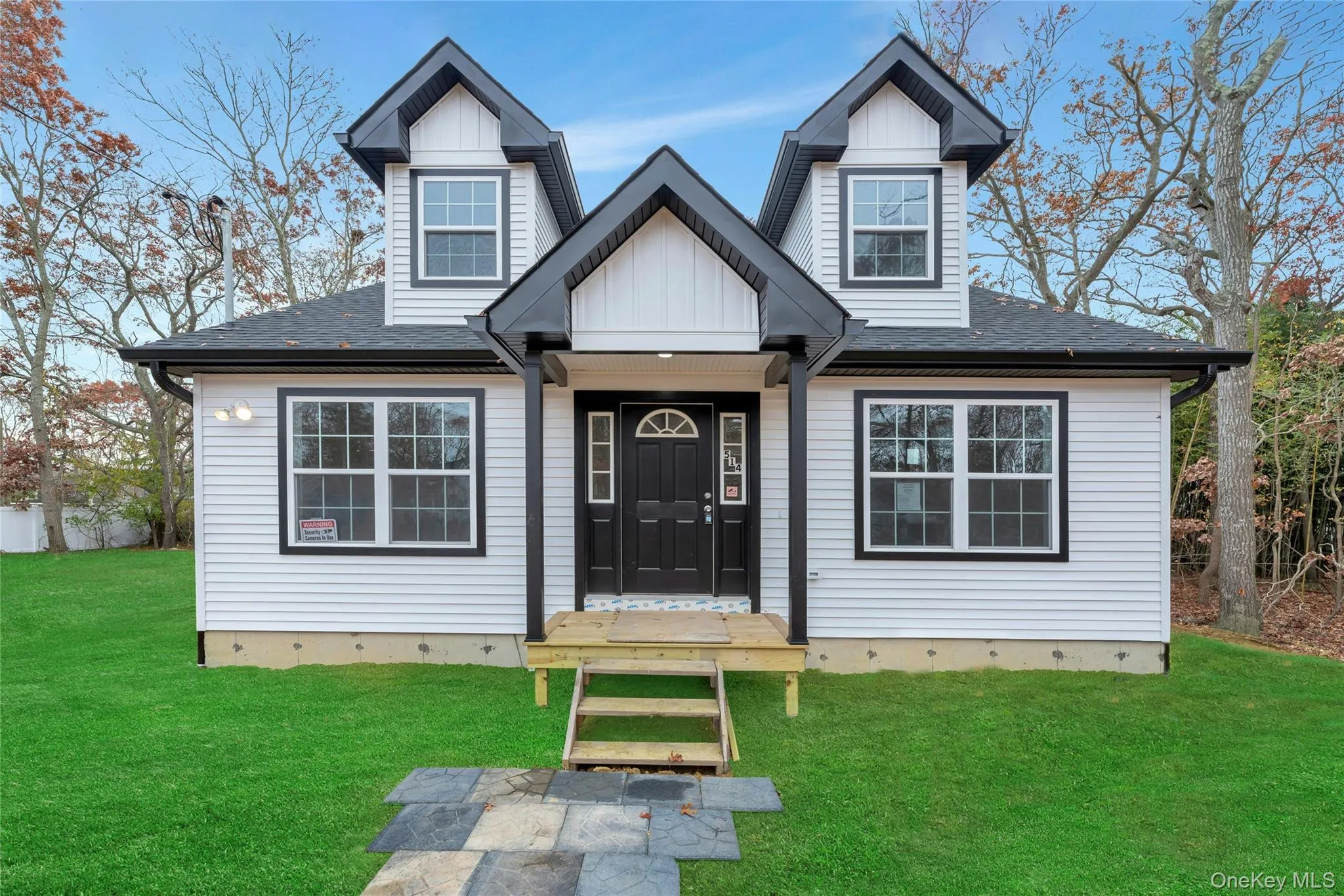 View of front of property featuring a front lawn, roof with shingles, and board and batten siding View of front of property featuring a front lawn, roof with shingles, and board and batten siding