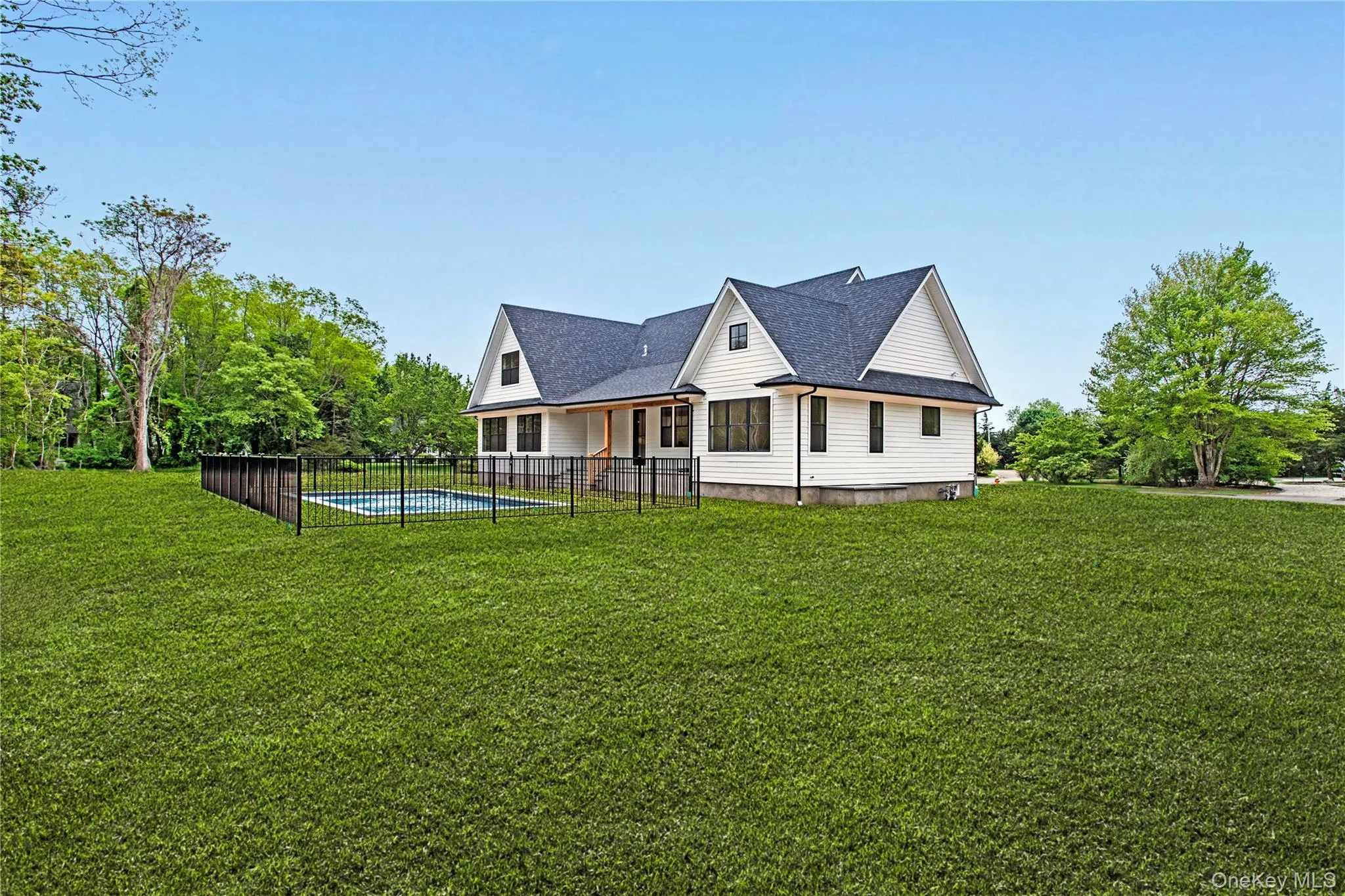 Back of property featuring a shingled roof Back of property featuring a shingled roof