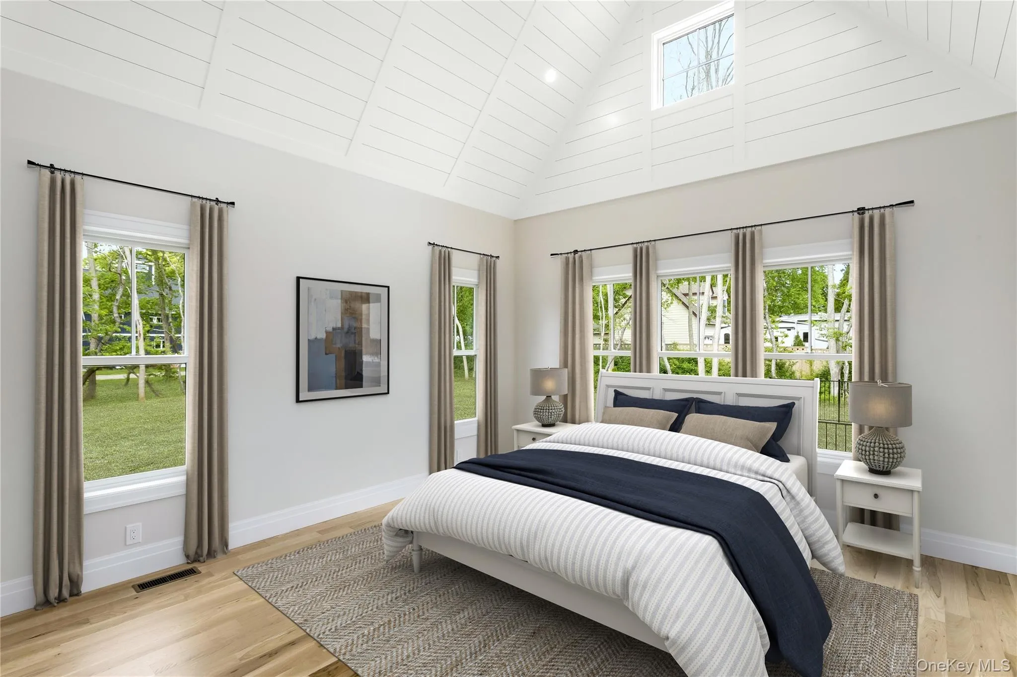 Primary Bedroom Staged featuring high vaulted ceiling, multiple windows, and light wood finished floors Primary Bedroom Staged featuring high vaulted ceiling, multiple windows, and light wood finished floors