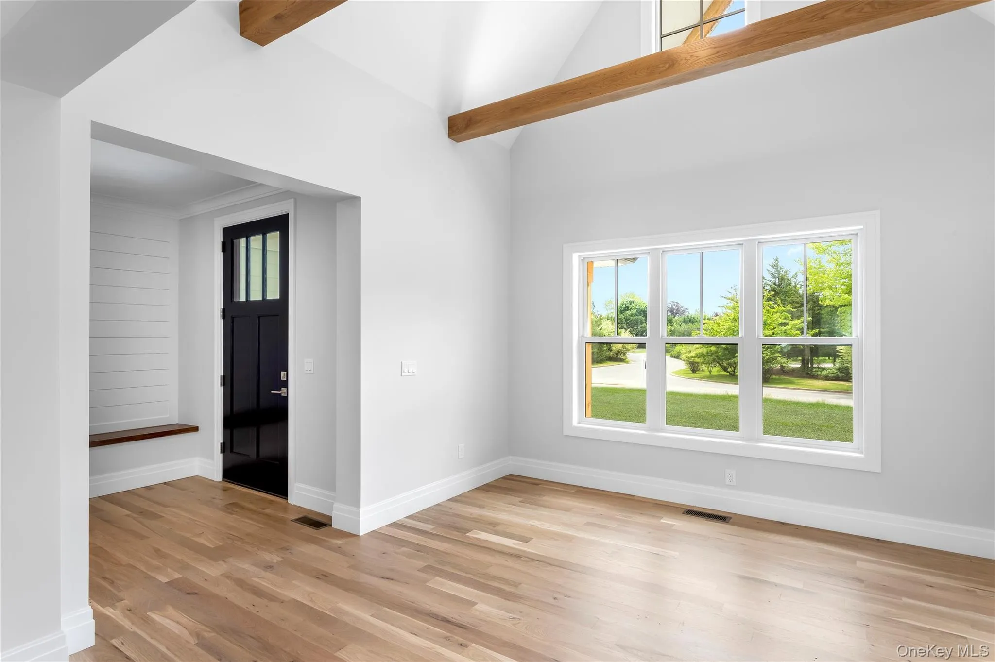 Dining Rm featuring plenty of natural light, light wood-type flooring, baseboards, and high vaulted ceiling Dining Rm featuring plenty of natural light, light wood-type flooring, baseboards, and high vaulted ceiling