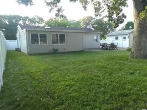 Back of house with a yard and a fenced backyard Back of house with a yard and a fenced backyard