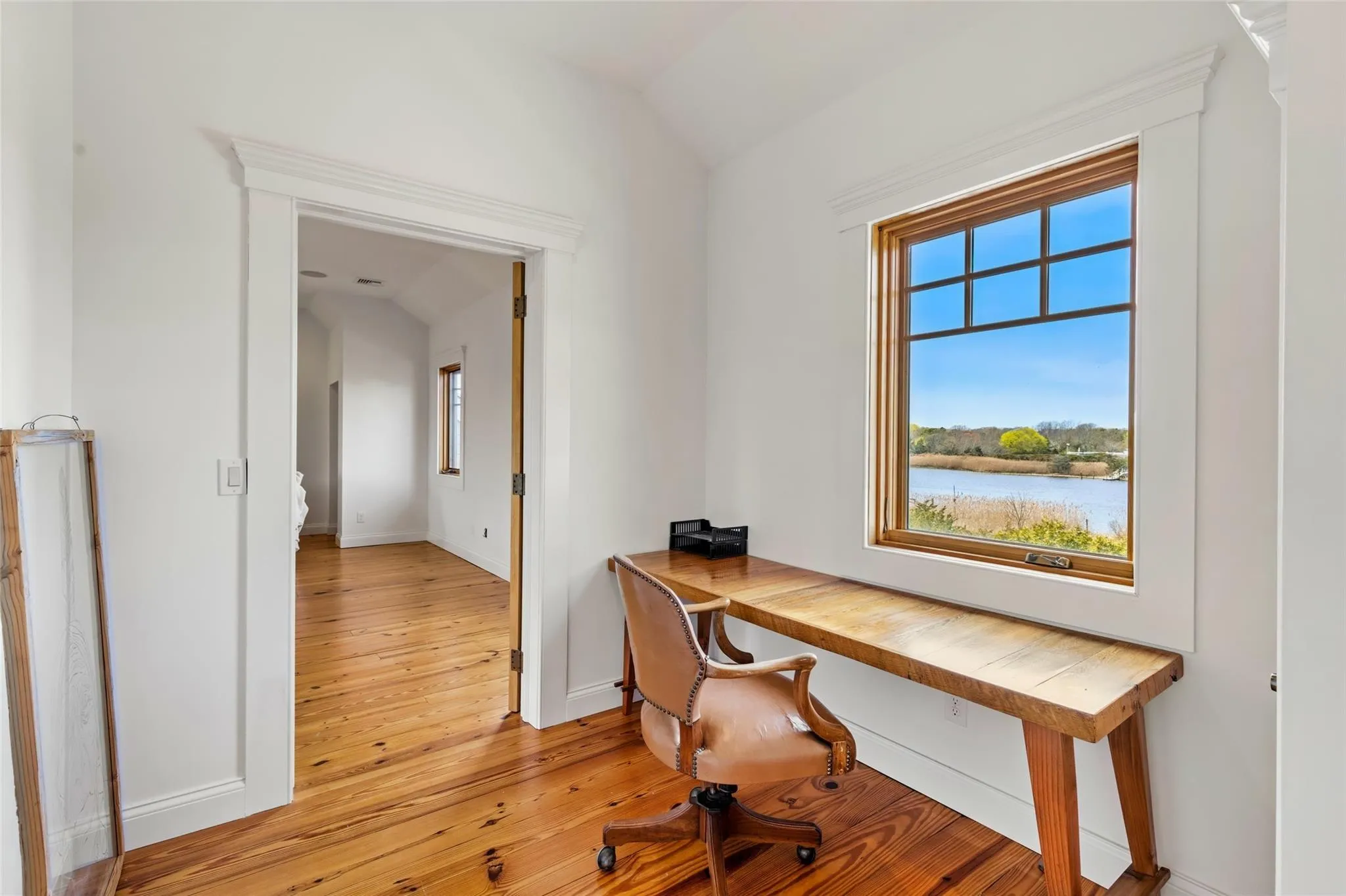 Office area with baseboards, light wood finished floors, and lofted ceiling Office area with baseboards, light wood finished floors, and lofted ceiling