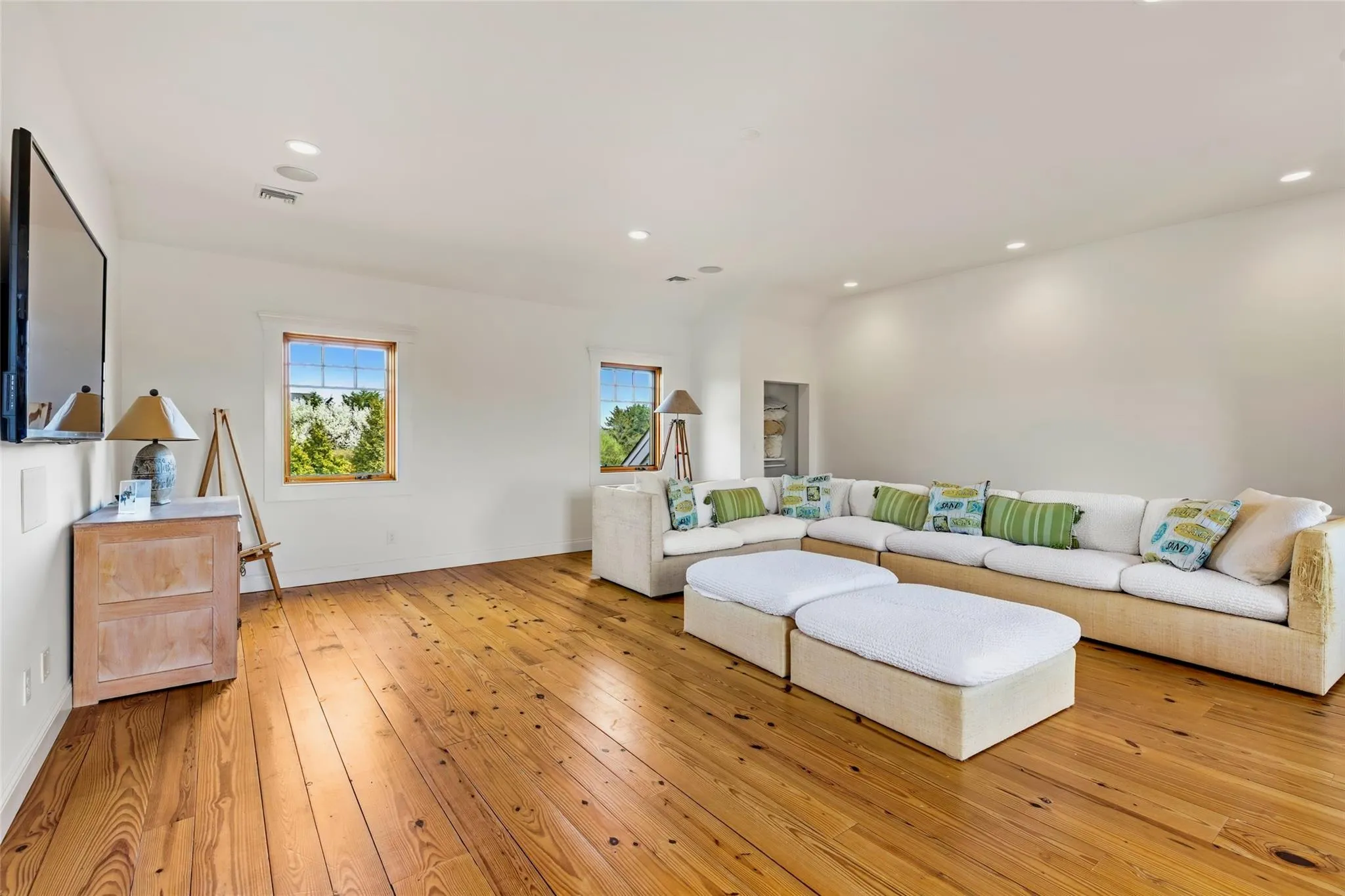 Living room featuring recessed lighting, baseboards, visible vents, and light wood finished floors Living room featuring recessed lighting, baseboards, visible vents, and light wood finished floors