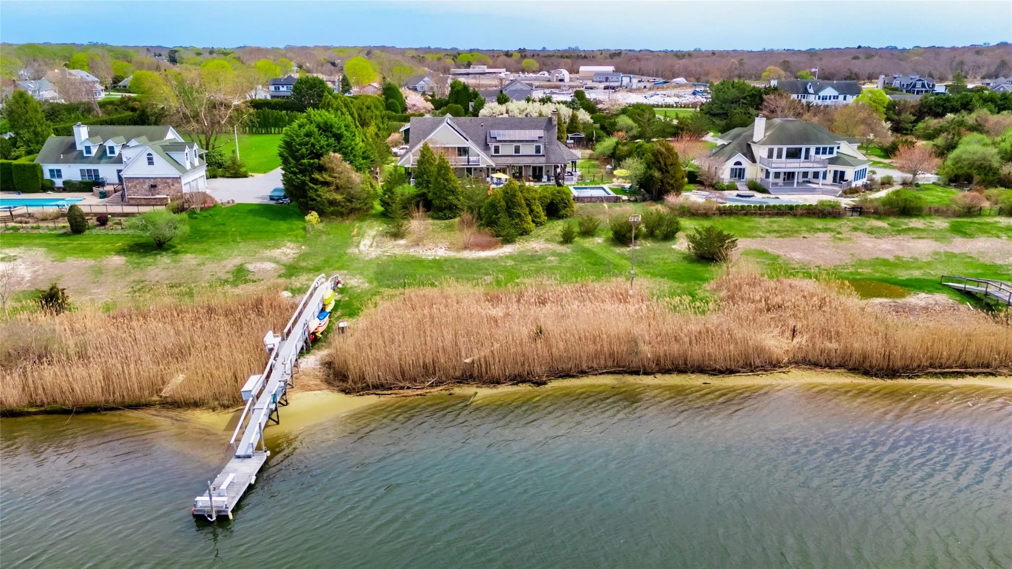 Drone / aerial view featuring a water view and a residential view Drone / aerial view featuring a water view and a residential view