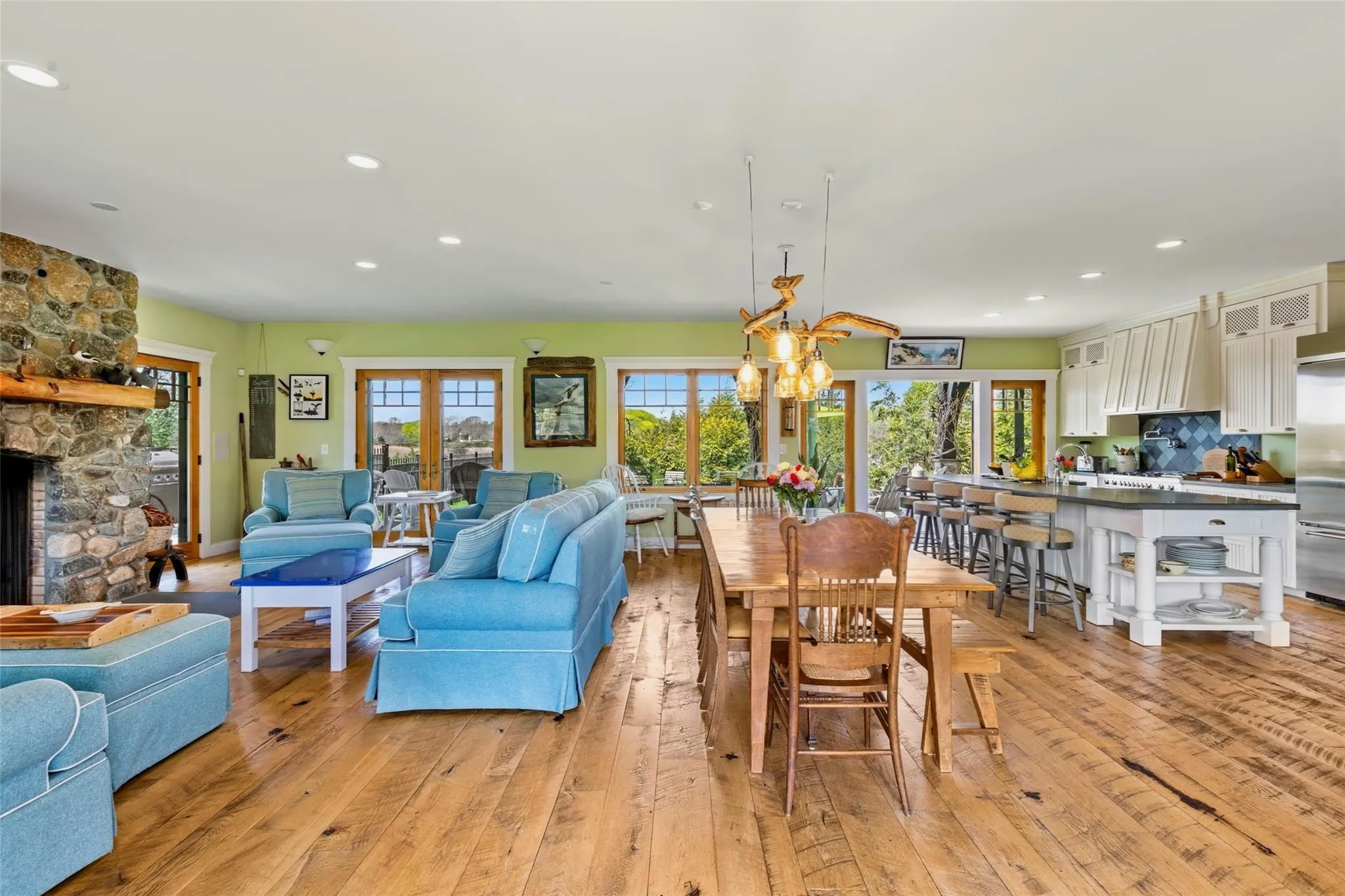 Dining room featuring recessed lighting, a chandelier, light wood finished floors, and a fireplace Dining room featuring recessed lighting, a chandelier, light wood finished floors, and a fireplace