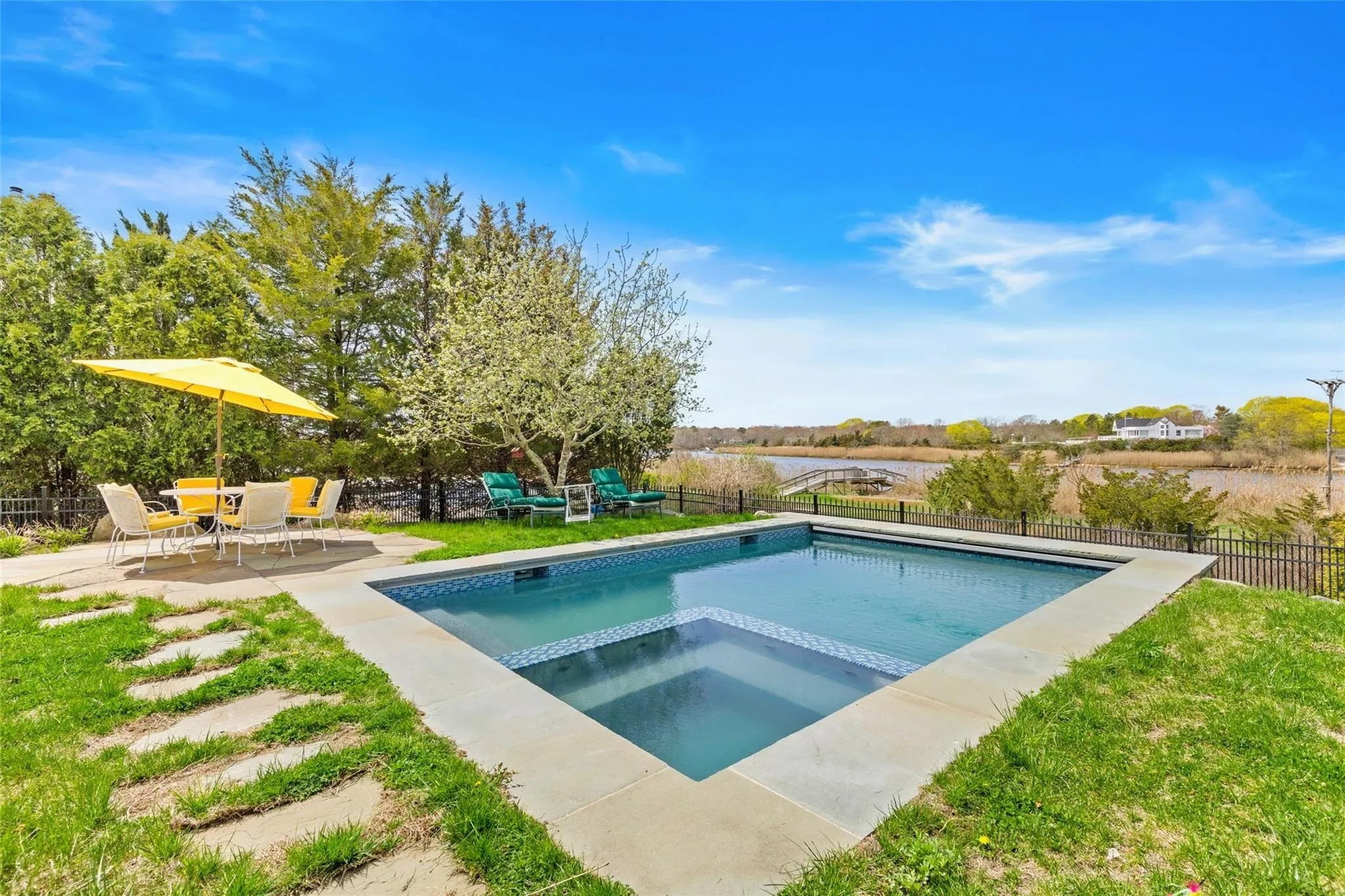 View of swimming pool with a fenced backyard, a patio, a yard, and a pool with connected hot tub View of swimming pool with a fenced backyard, a patio, a yard, and a pool with connected hot tub