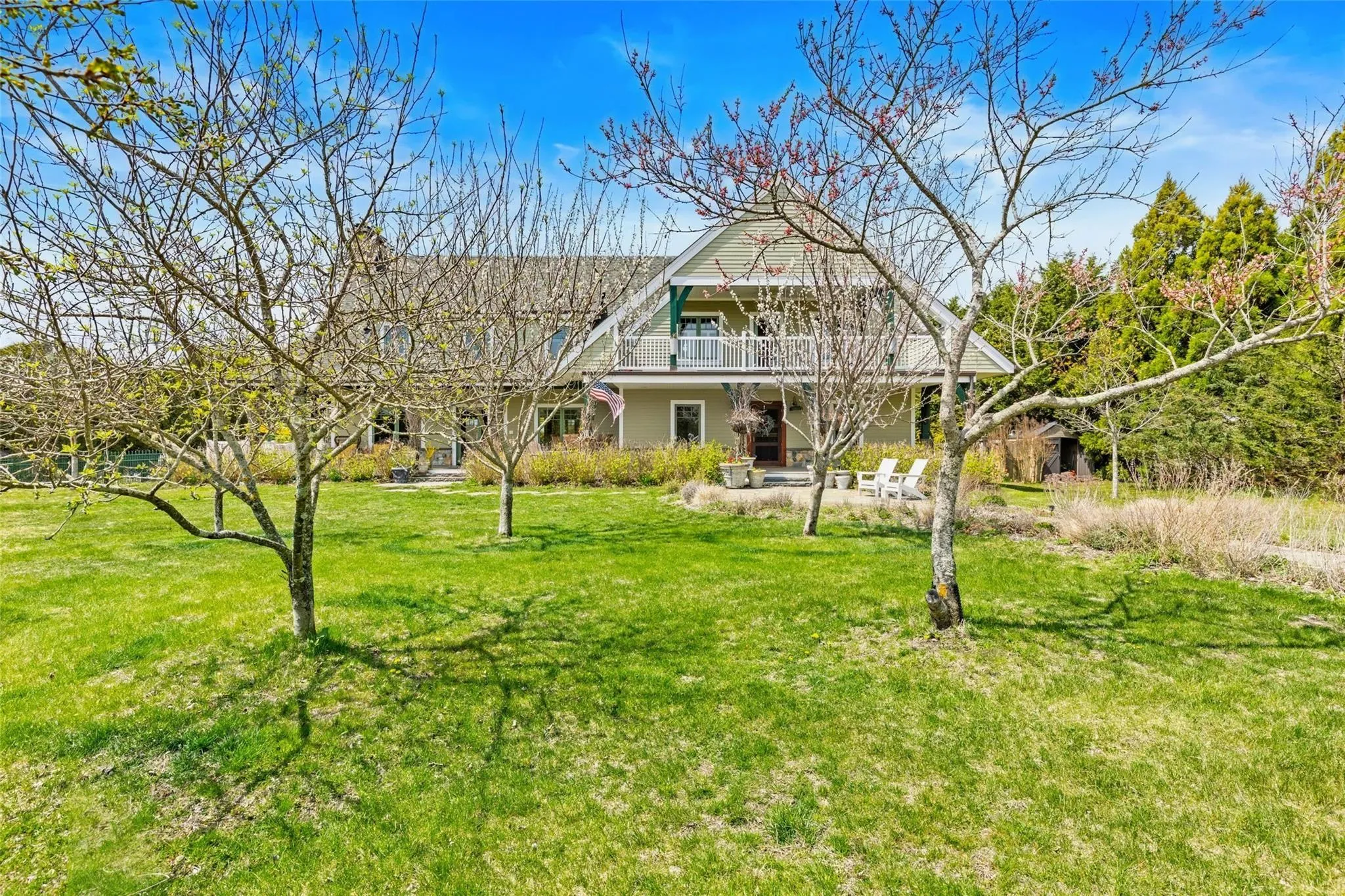 View of front of house with a patio, a balcony, and a front yard View of front of house with a patio, a balcony, and a front yard