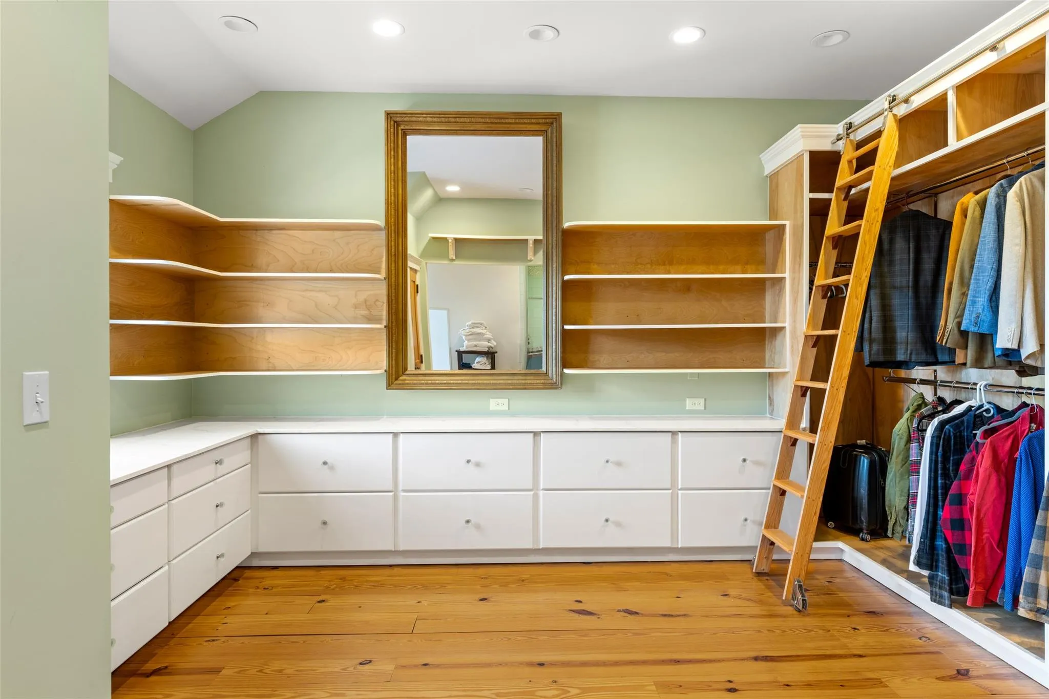 Spacious closet with vaulted ceiling and light wood finished floors Spacious closet with vaulted ceiling and light wood finished floors