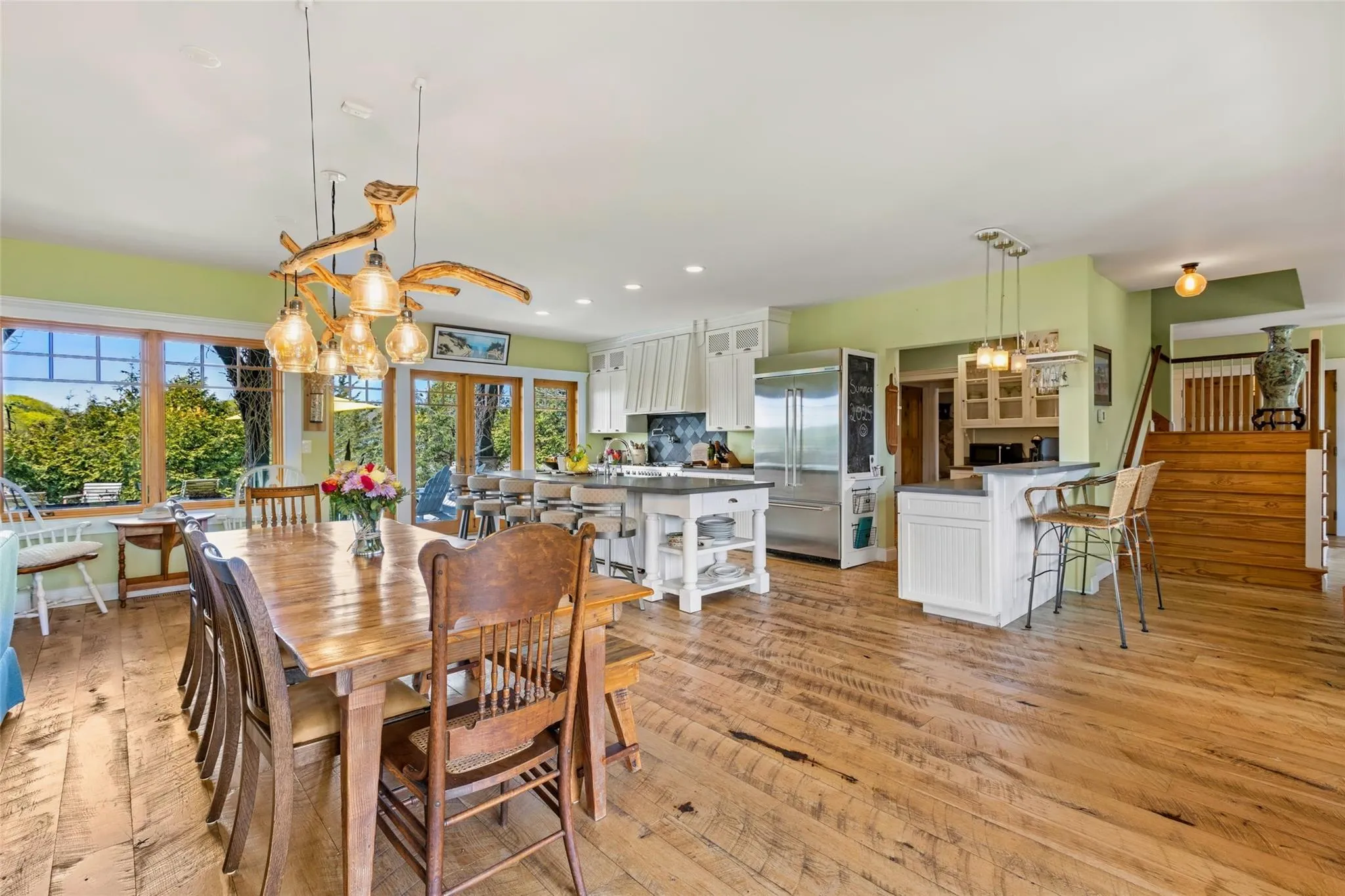 Dining area featuring light wood-style floors, recessed lighting, a healthy amount of sunlight, and stairway Dining area featuring light wood-style floors, recessed lighting, a healthy amount of sunlight, and stairway