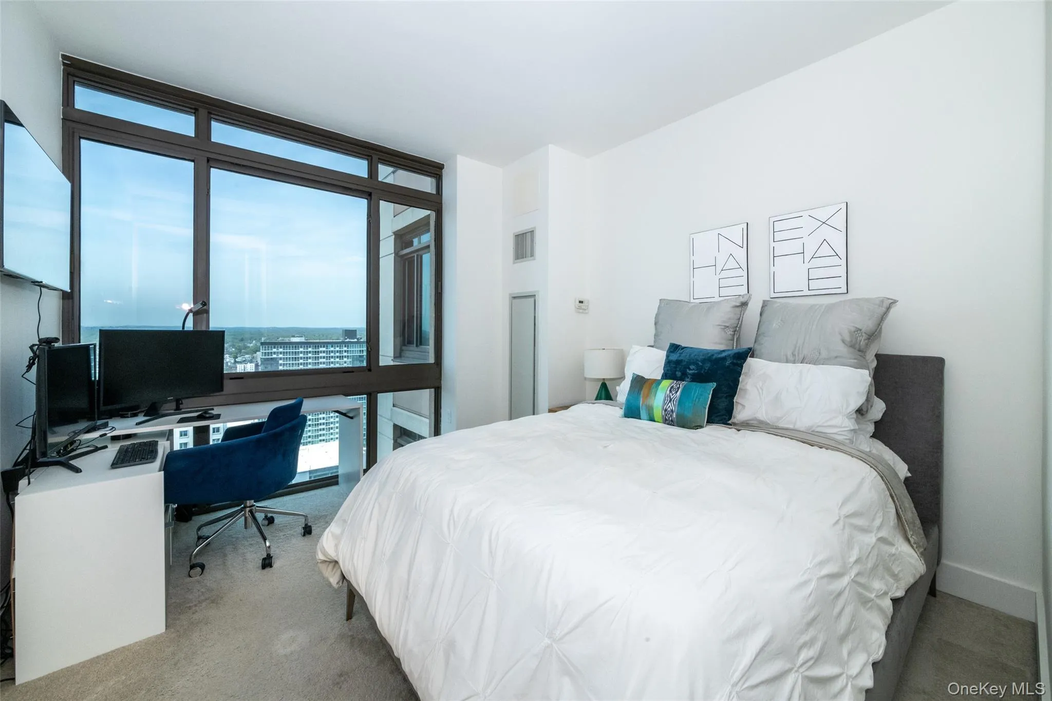 Carpeted bedroom featuring expansive windows Carpeted bedroom featuring expansive windows