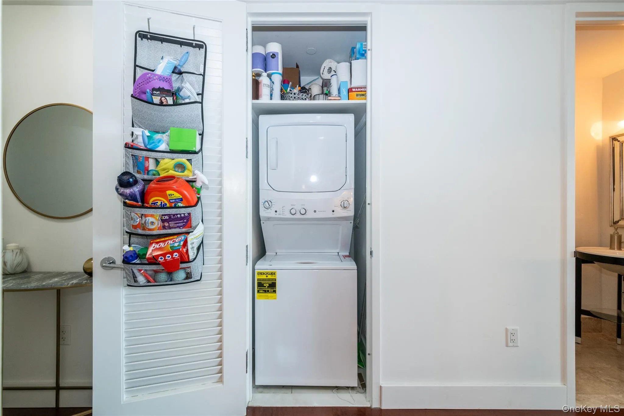 Washroom featuring laundry area and stacked washer and dryer Washroom featuring laundry area and stacked washer and dryer