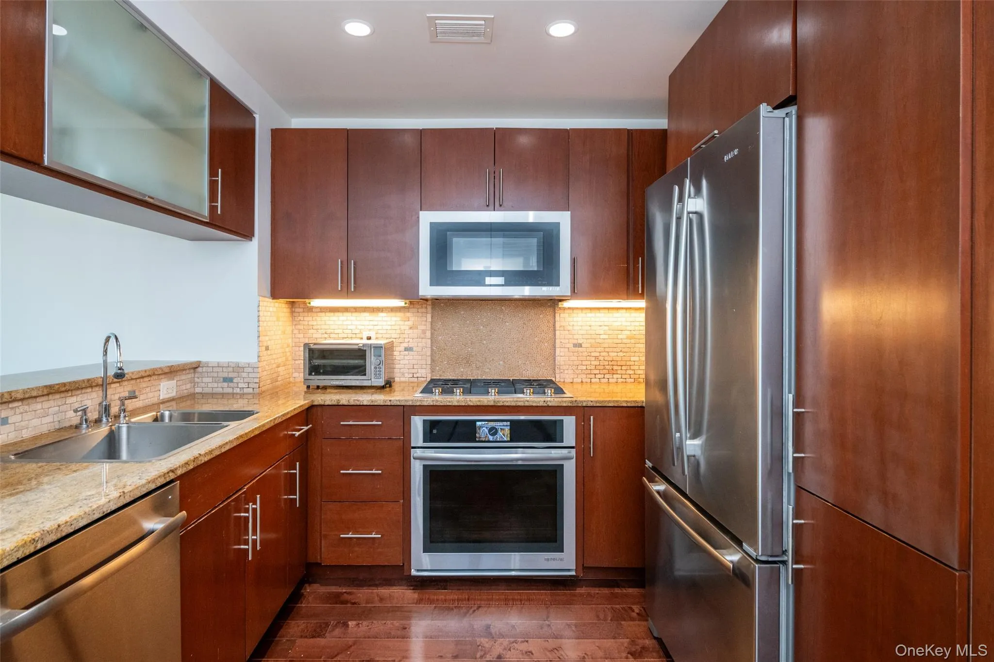 Featuring dark wood-style floors, and stainless steel appliances Featuring dark wood-style floors, and stainless steel appliances