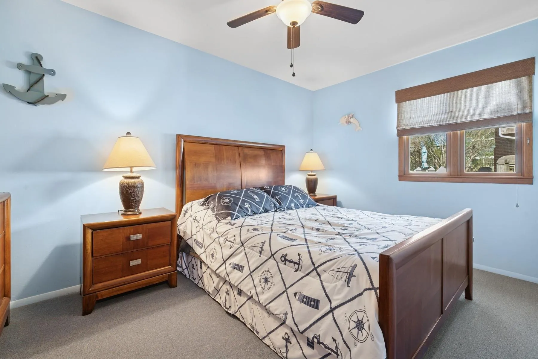 Bedroom with baseboards, ceiling fan, and light carpet Bedroom with baseboards, ceiling fan, and light carpet