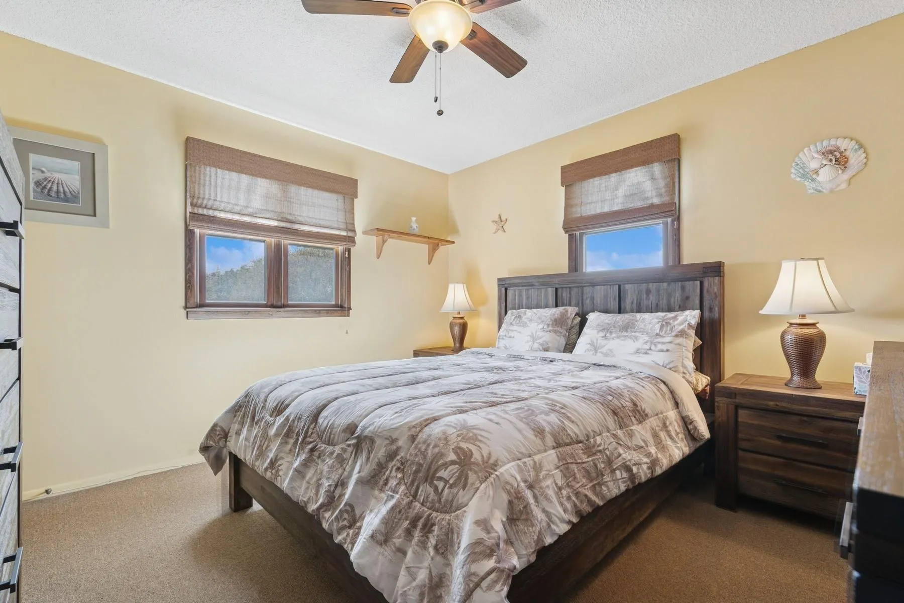 Bedroom featuring baseboards, ceiling fan, carpet, and a textured ceiling Bedroom featuring baseboards, ceiling fan, carpet, and a textured ceiling
