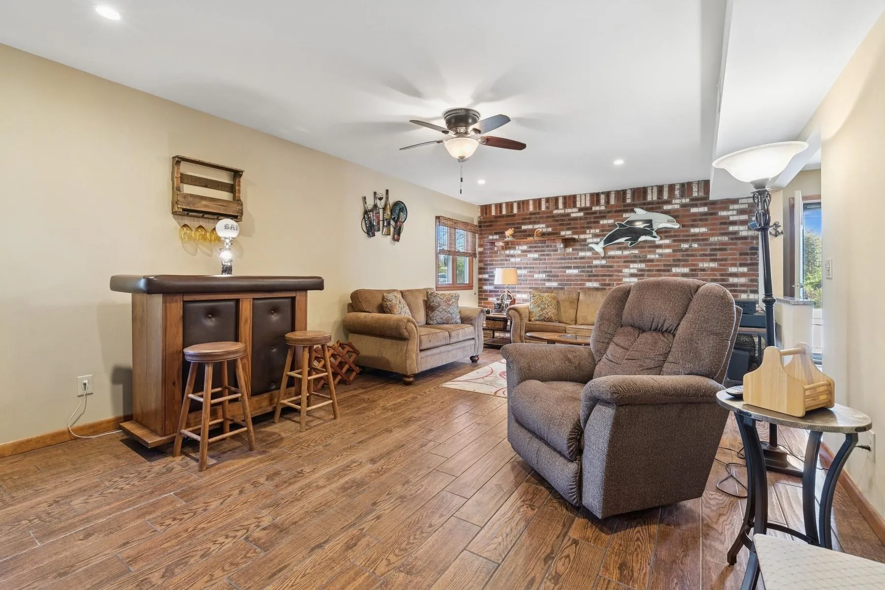 Living area featuring recessed lighting, baseboards, ceiling fan, and wood finished floors Living area featuring recessed lighting, baseboards, ceiling fan, and wood finished floors